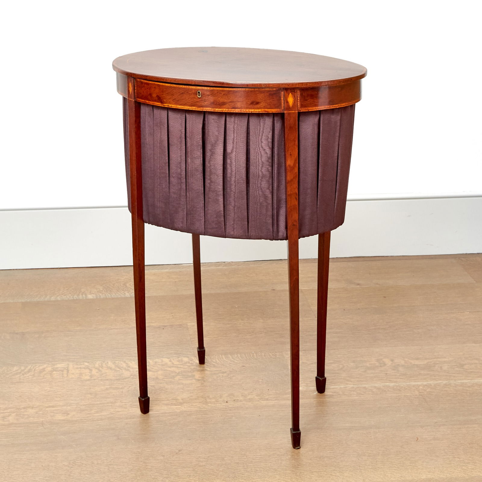 Attributed to Charleston: Federal Plum Pudding Mahogany Work Table: 1790sThe hinged oval top opening to a work basket, raised on slender tapering square legs ending in spade feet. Height 29 1/8 inches, width 19 3/4 inches; depth 14 inches.Provenance: Estate Antiques,