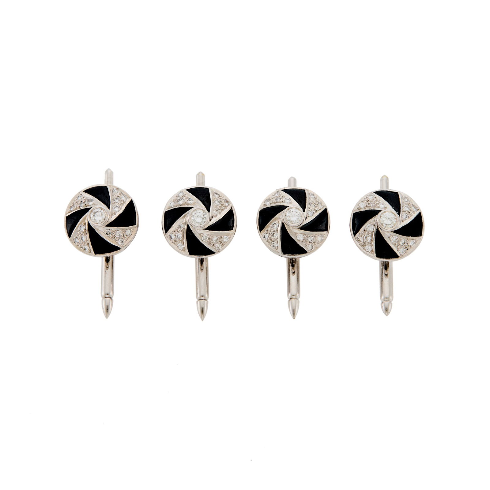 Four White Gold, Black Onyx and Diamond Shirt Studs: 18 kt., fancy-shaped black onyx, round diamonds ap. 1.00 ct., no. 16333 and 16332, ap. 6.8 dwts. Diameters 7/16 inch.