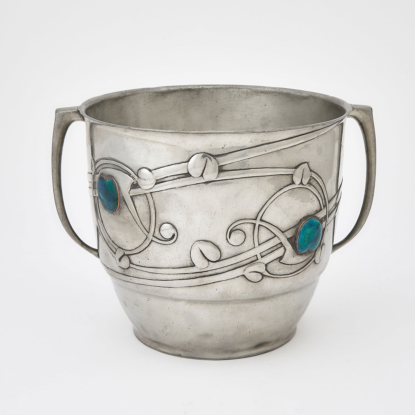 Liberty & Co. Art Nouveau Tudric Pewter and Enamel Twin-Handled Ice Bucket: Model no. 0706, early 20th century The tapering circular body cast with Celtic-inspired meandering stylized vines and leaves, with four applied mottled blue and green enameled stylized leaves, impress