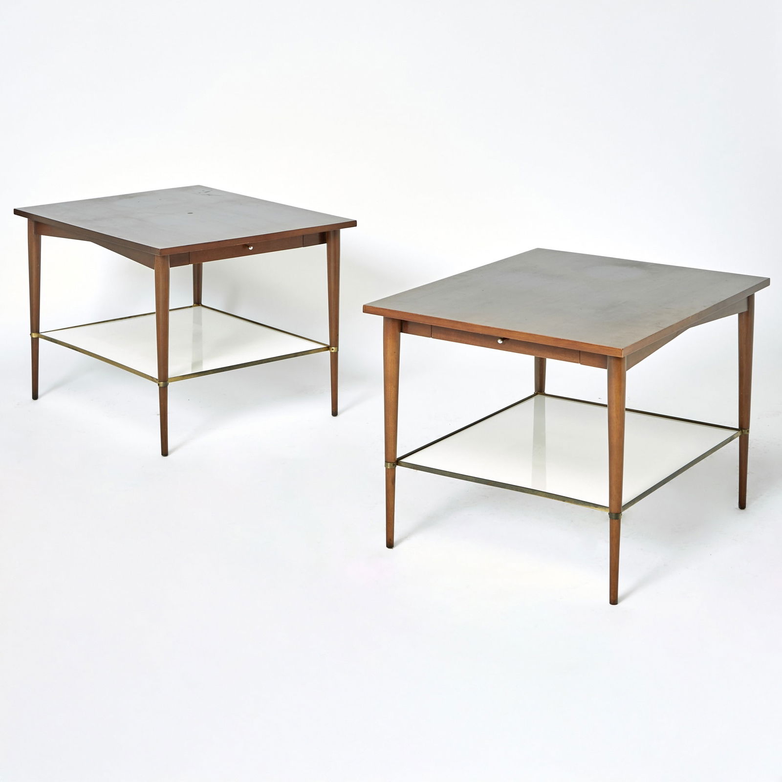 Pair of Paul McCobb Connoisseur Collection Walnut Side Tables: H. Sacks & Sons, mid 20th centuryWith glass shelves. Height 22 1/4 nches, width 24 inches, depth 30 inches.