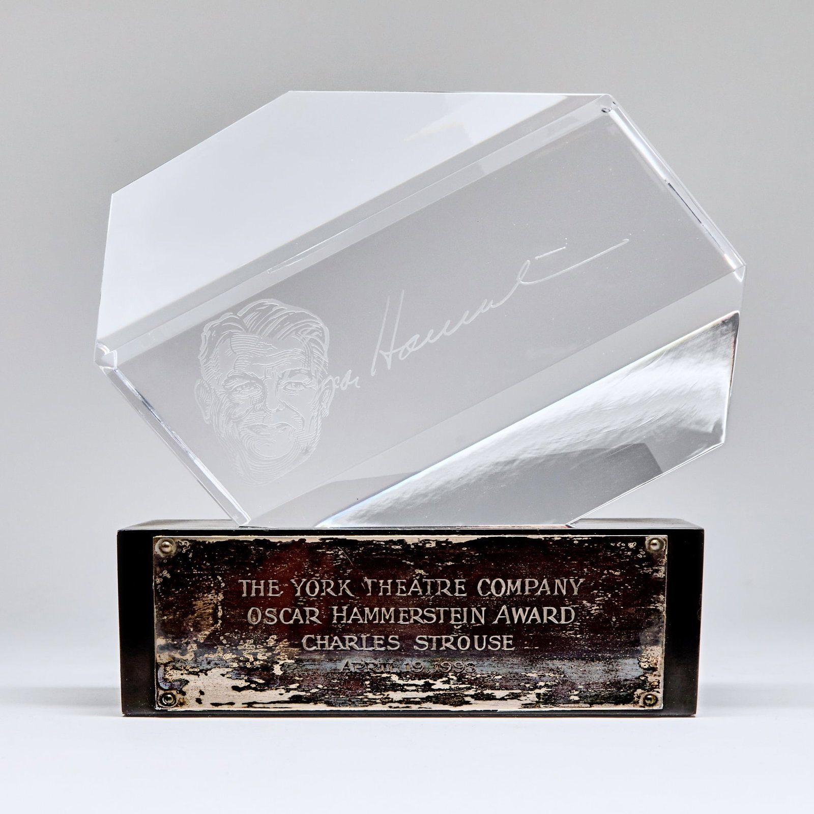 The New York Theatre Company Oscar Hammerstein Award presented to Charles Strouse: CHARLES STROUSEThe New York Theatre Company Oscar Hammerstein Award presented to Charles Strouse. 19 April 1993. Etched glass freestanding on a polished wood base, two parts, approximately 7 x 3 1/2