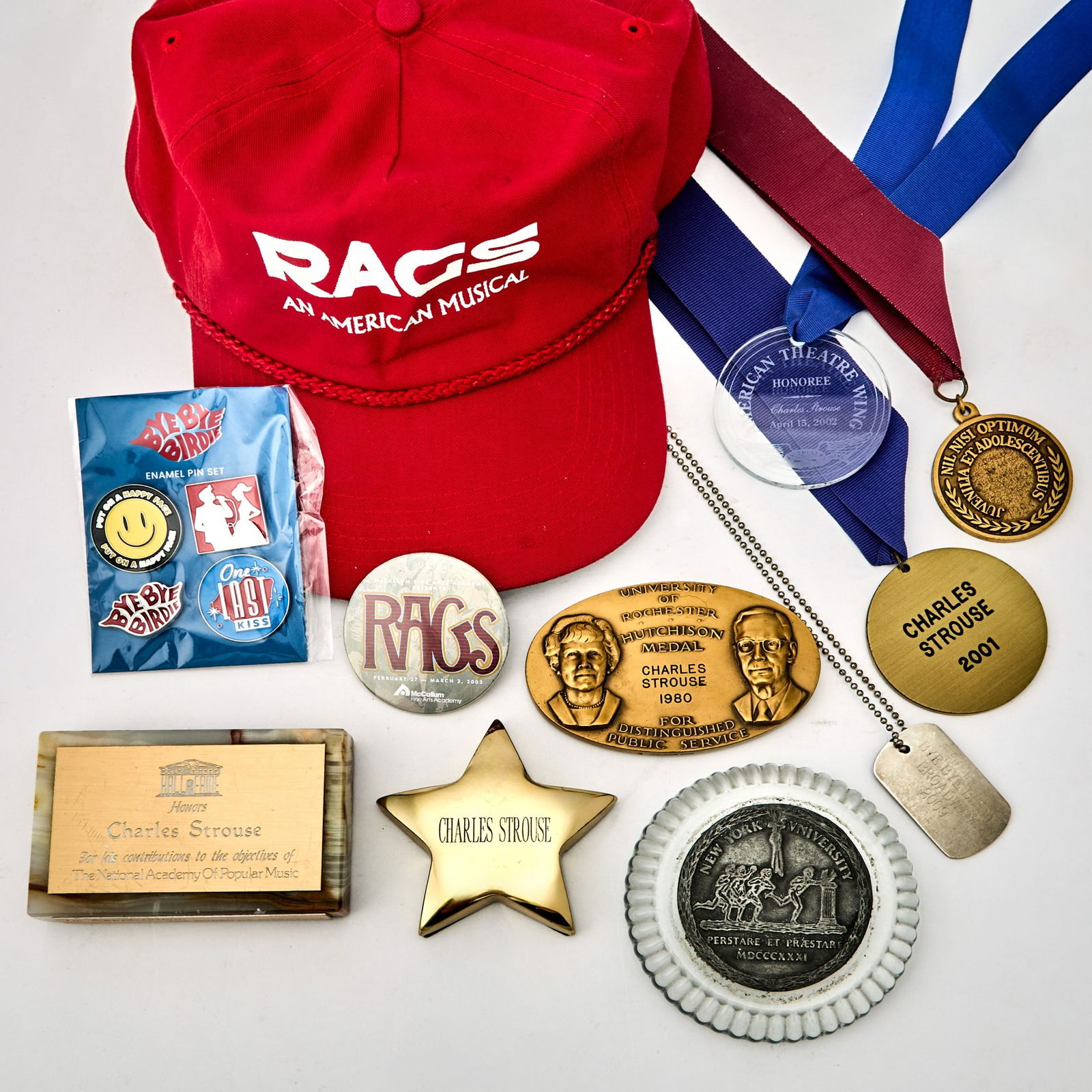 Group of Charles Strouse memorabilia.: CHARLES STROUSE Group of Charles Strouse memorabilia. Comprising: Bye Bye Birdie, 2009 Broadway dog tag; Theatre of Hall of Fame medallion 2001; Children’s Theatre medallion 1994; American
