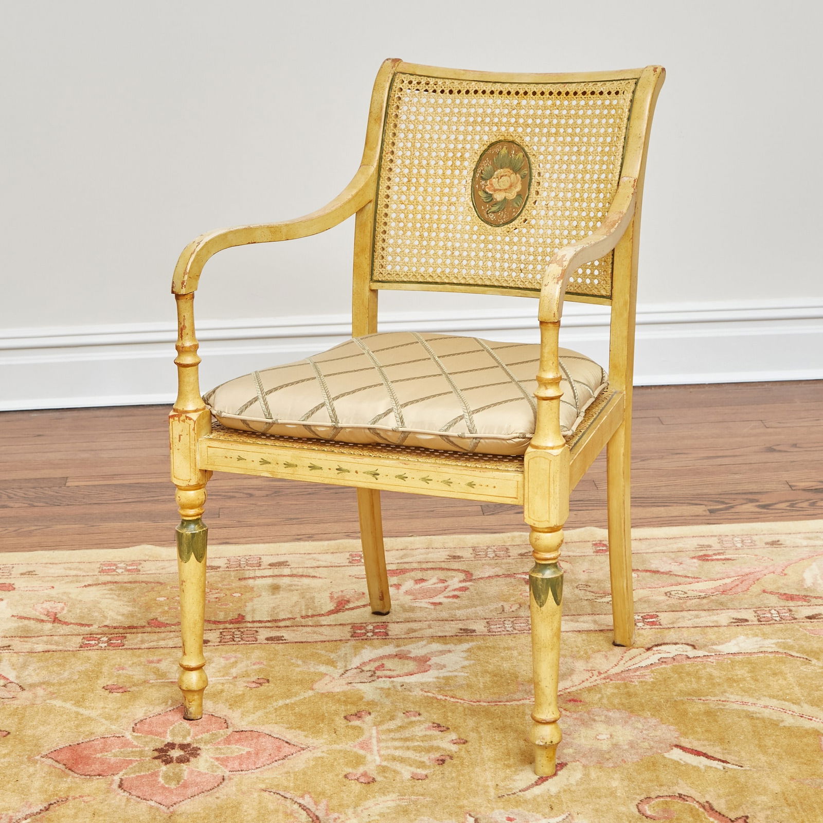 Edwardian Style Painted Caned Armchair: Shown in the November 1995 Architectural Digest "Broadway at Home" issue. Height 35 inches, width 20 1/2 inches, depth of seat 17 inches, height of seat 18 inches. flaking and paint losses