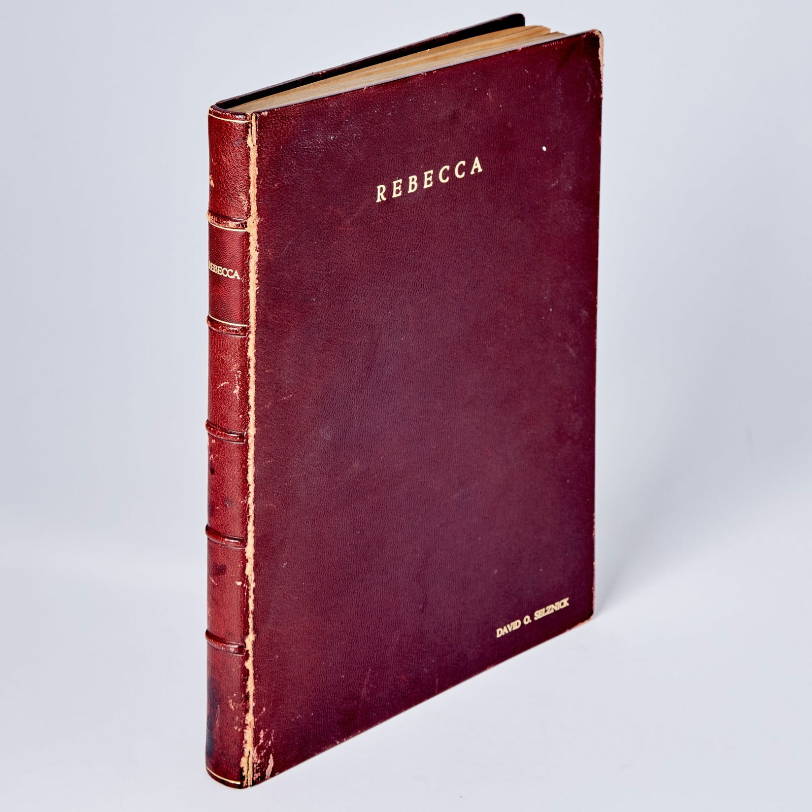 A presentation copy with photographs of the shooting script for Rebecca, stamped on the cover for: [ALFRED HITCHCOCK] Rebecca. Selznick International, 1939. David O. Selznick's copy of the final shooting script. Maroon leather with title gilt on cover and spine, Selznick's name gilt on lower corner