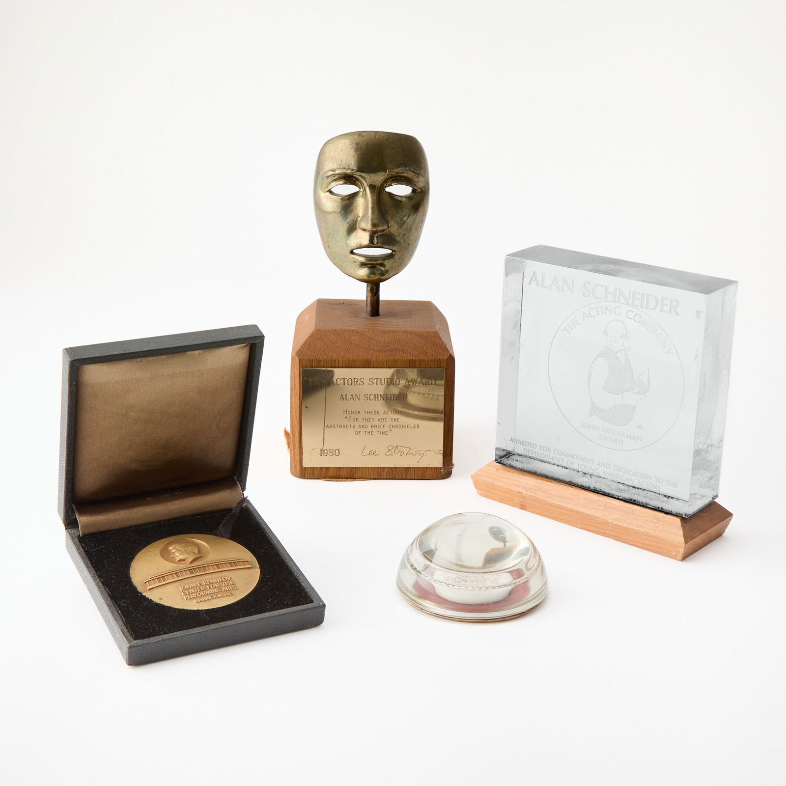 Three awards and a paperweight presented to director Alan Schneider: [ALAN SCHNEIDER - AWARDS] Three awards and a paperweight presented to Alan Schneider. 1) Actors Studio Award, 1980. Bronze mask mounted on wood pedestal with plaque. 8 1/2 x 4 inches (21.5 x 10 cm).