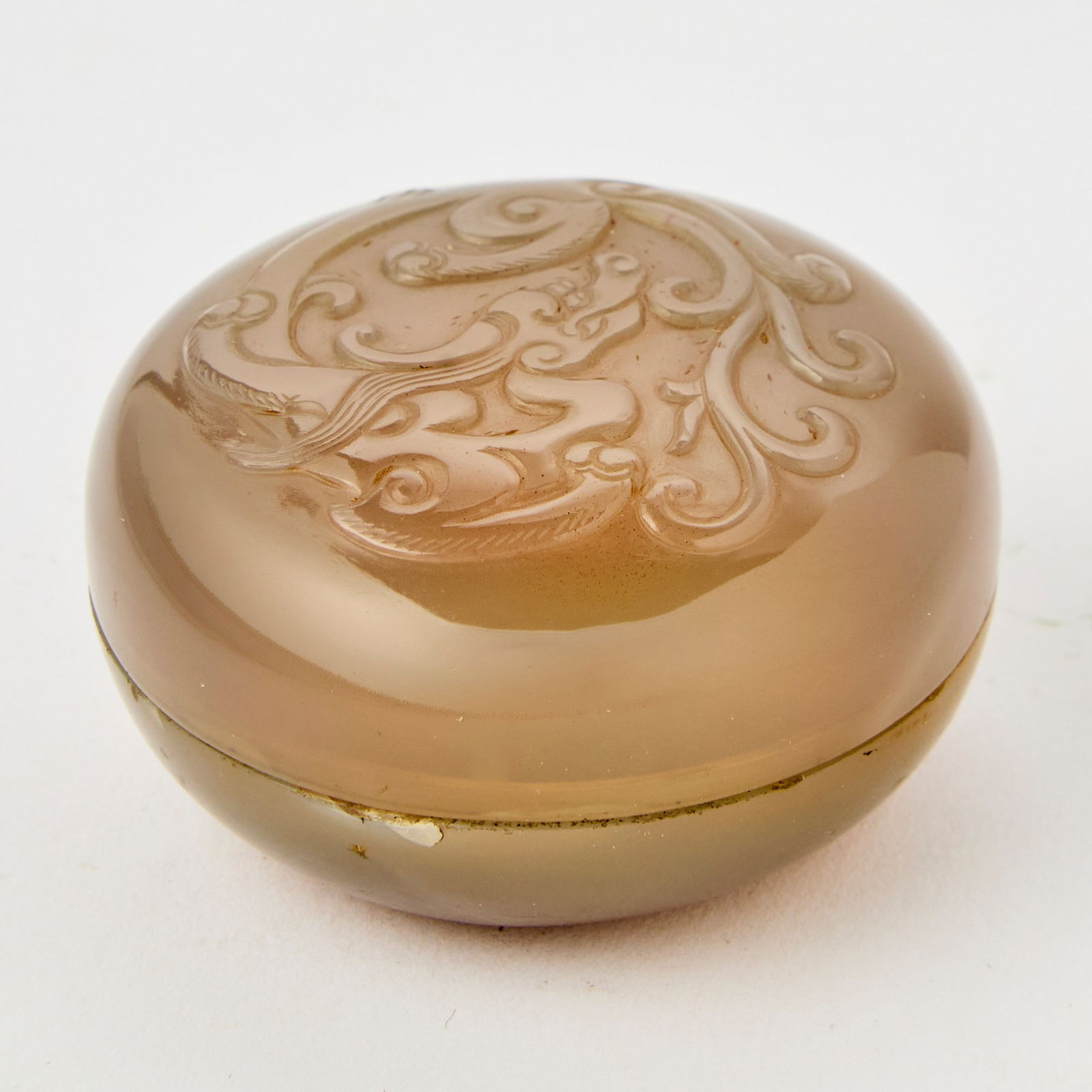 A Fine Chinese Carved Agate Circular Box and Cover 18th century: Of domed form, the cover carved with a sinuous chilong amidst scrolling tendrils. (Diameter 2 inches)