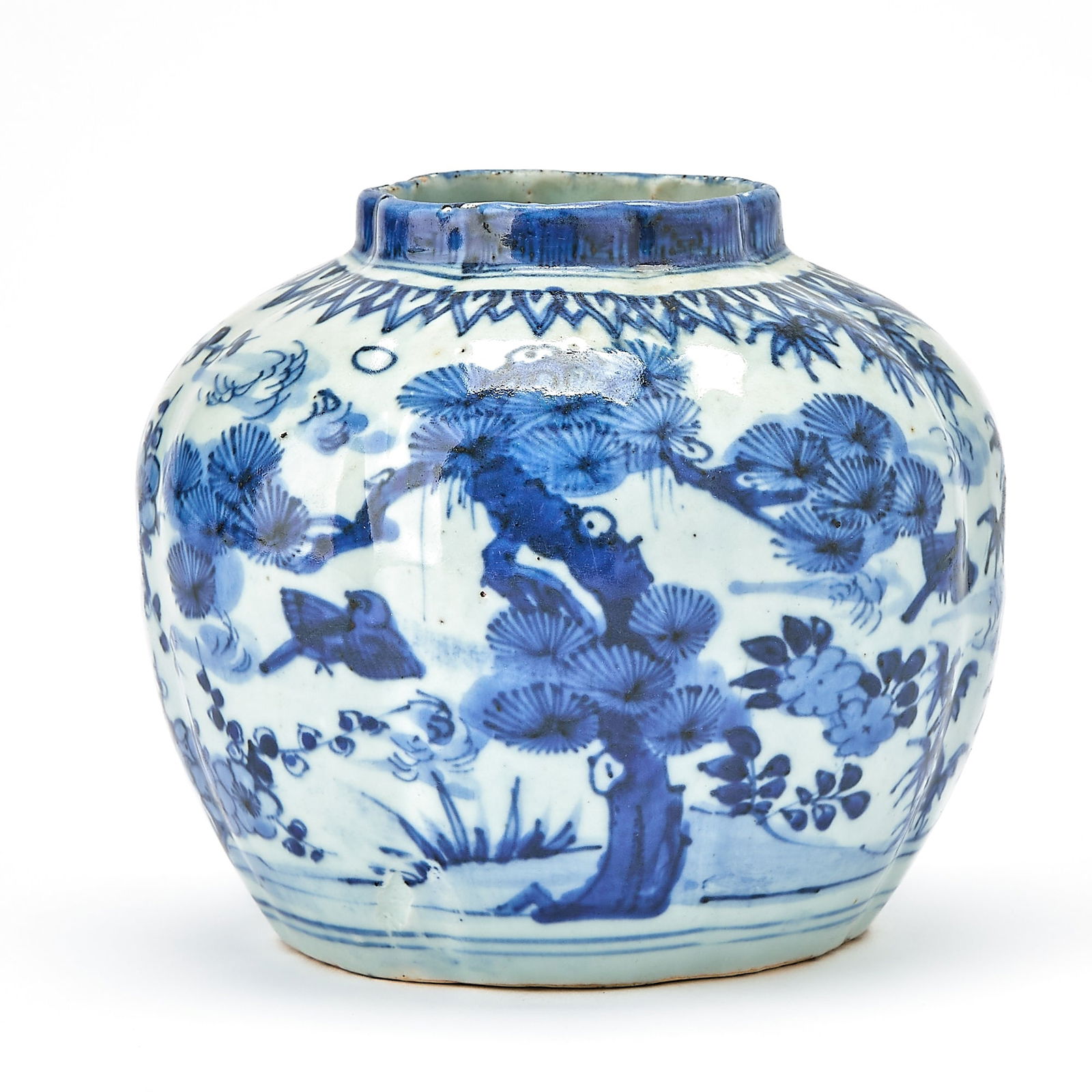 A Chinese Blue and White Porcelain Lobed Jar Ming Dynasty: The globular body decorated with birds in flight amid prunus, pine, bamboo, and other plants. (Height 5 1/2 inches) Chait Galleries, New York; with label.