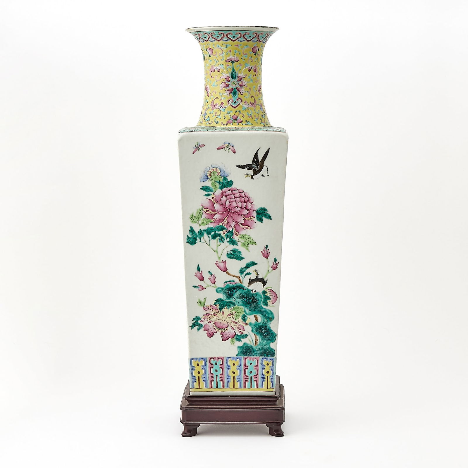 A Chinese Enameled Porcelain Tapering Square Form Vase Qing Dynasty: Decorated to show peony, lotus, chrysanthemum and prunus blossoms on leafy branches, with birds, dragonflies, and butterflies. (Height 20 1/4 inches)