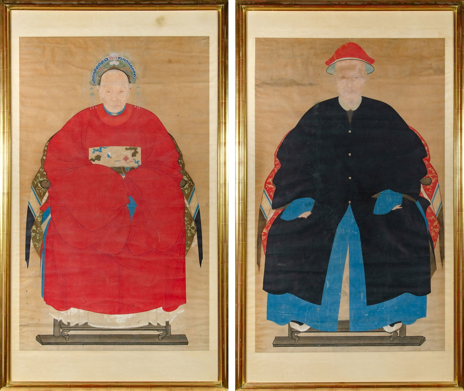 A Large Pair of Chinese Portraits 1st half 19th Century: Ink and color on paper; matted and framed. Depicting a seated male and female figure in formal attire. (Sight Heights 50 inches)