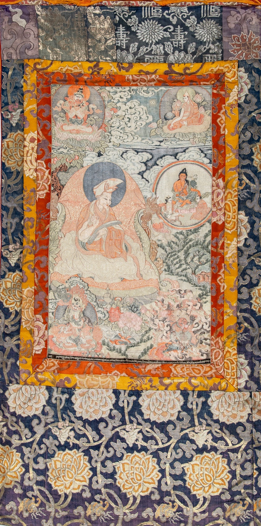 A Tibetan Silk Embroidered Thangka 20th Century: Depicting the fourth Panchen lama Lobsang Chokyi Gyaltsen. (Sight 26 3/4 x 16 inches; overall 51 x 27 inches)