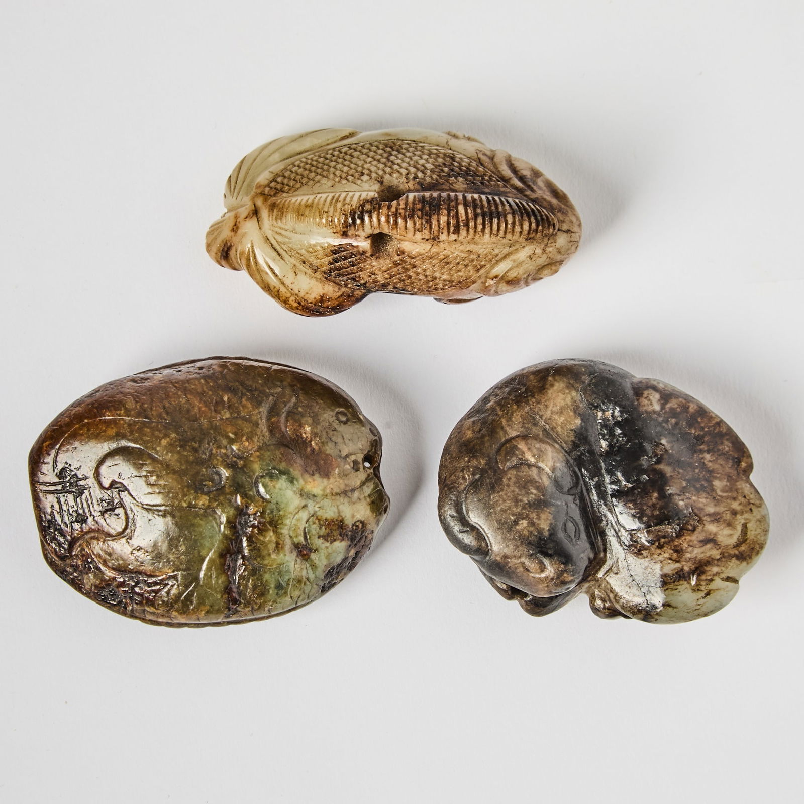 A Group of Three Chinese Mottled Jade Toggles Ming Dynasty (1 of 6)