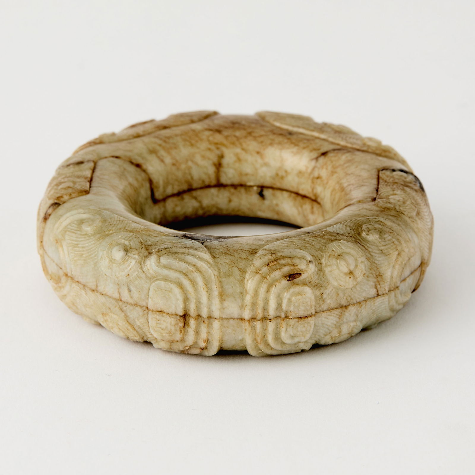 A Chinese Archaistic Conjoined Jade Ring Qing Dynasty: Of mottled tone; deftly carved as two interlocked, conjoining rings. (Diameter 3 inches)