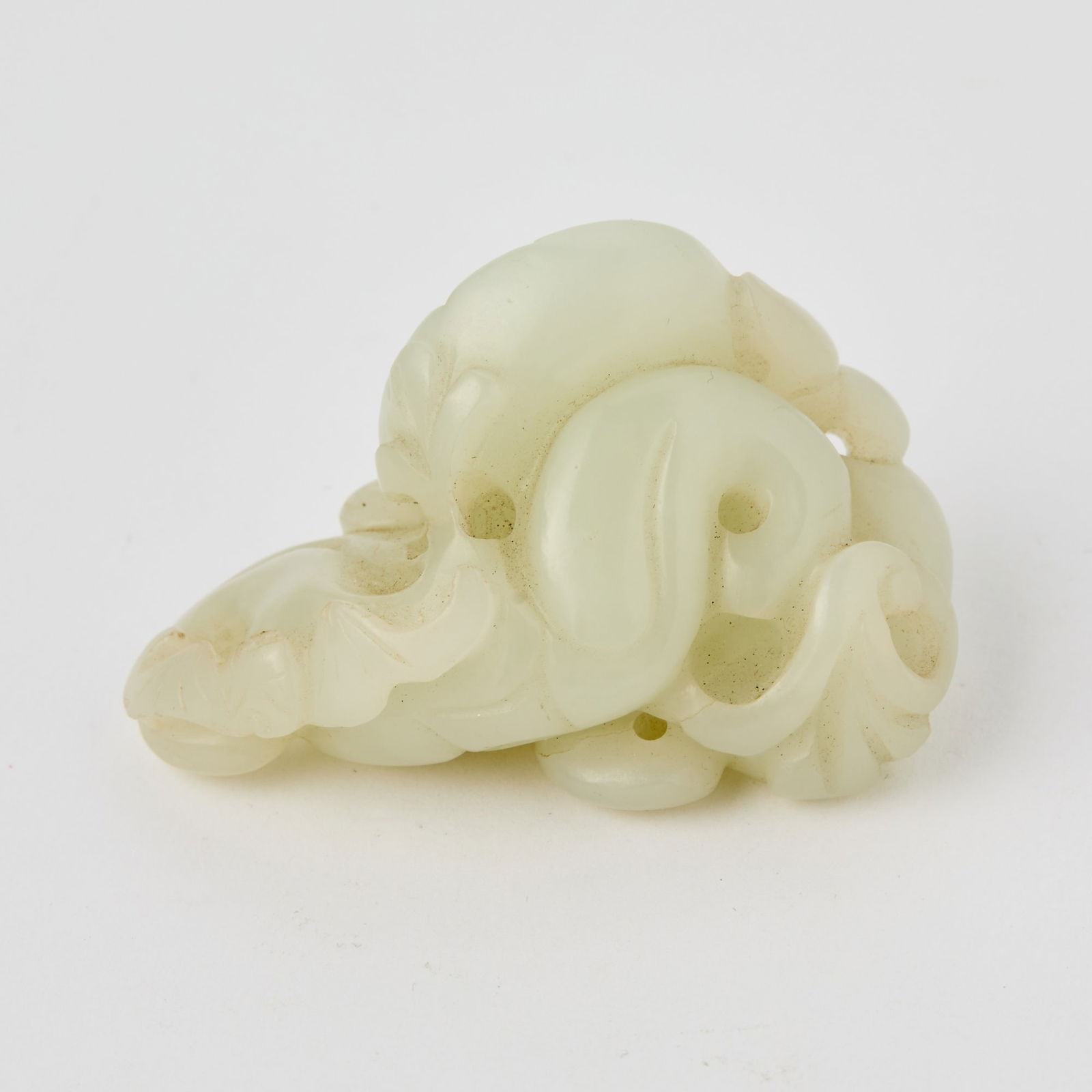 A Chinese White Jade Carving of a 'Water Chestnut Grouping' 18th-19th century: Carved in a perforated form. (Length 2 1/4 inches)