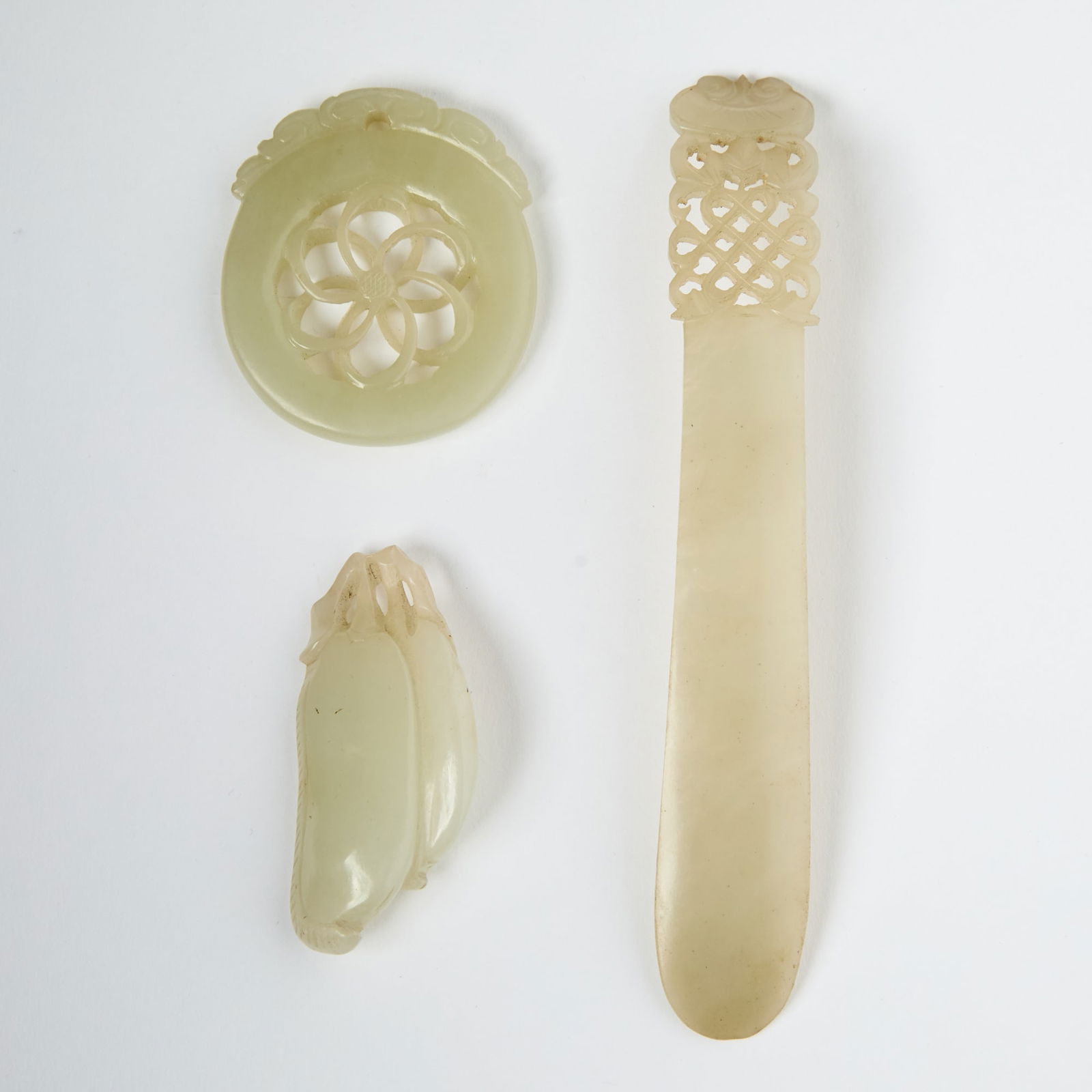 Three Chinese Celadon Jade Articles 18th-19th century: Comprising a hair ornament and two pendants. (Length of largest 5 inches)
