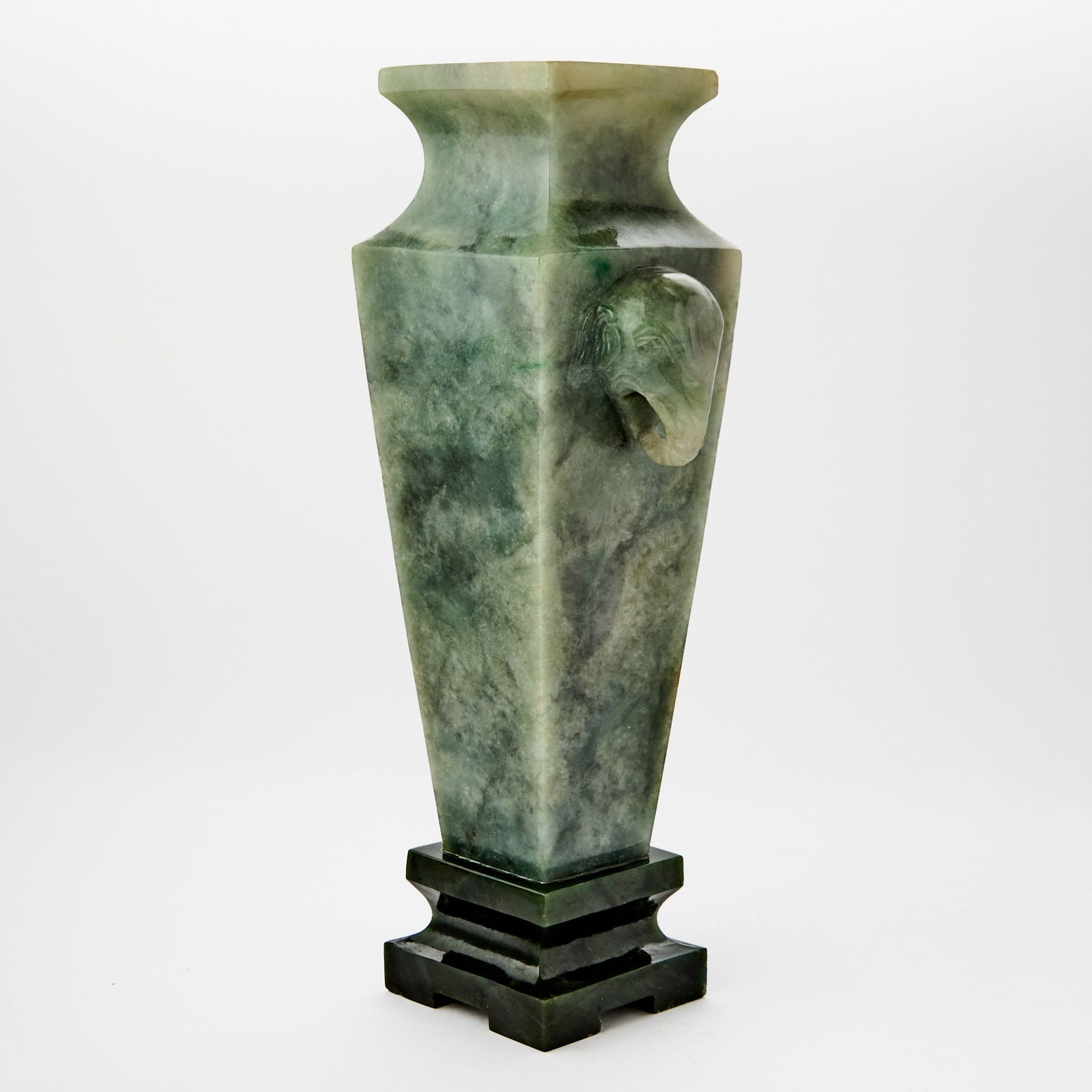 A Chinese Jadeite Square Form Vase Likely Republic Period: Of tapering, square-sectioned form and carved with elephant head handles; mounted in spincah jade base. (Height 11 inches)