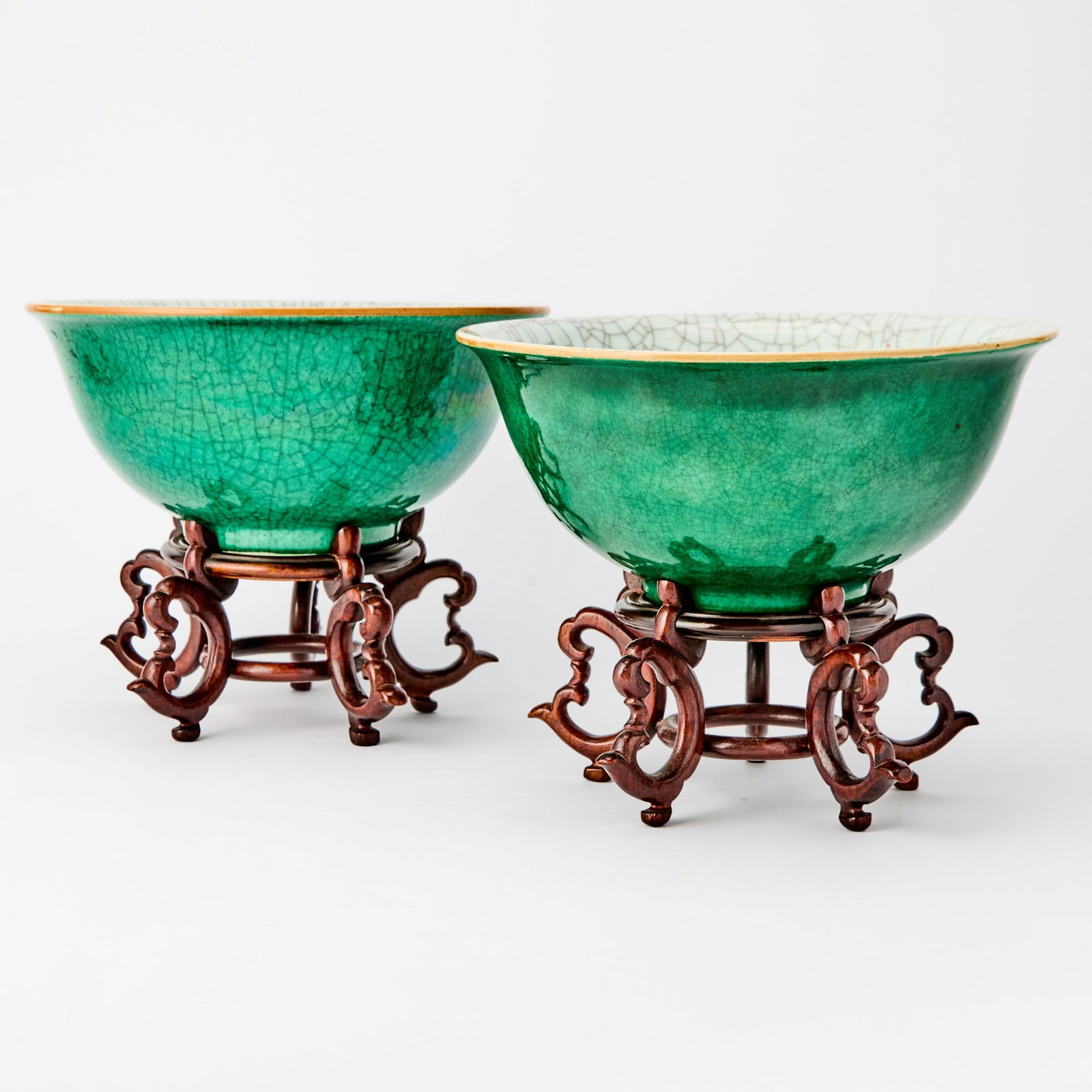 A Pair of Chinese Crackle Glaze Green Porcelain Bowls Qing Dynasty: The wide bowls with everted rims decorated to exterior with apple green glaze and with white glaze to interior, all with tight and eccentric craquelure showing. (Diameter 10 1/4 inches)