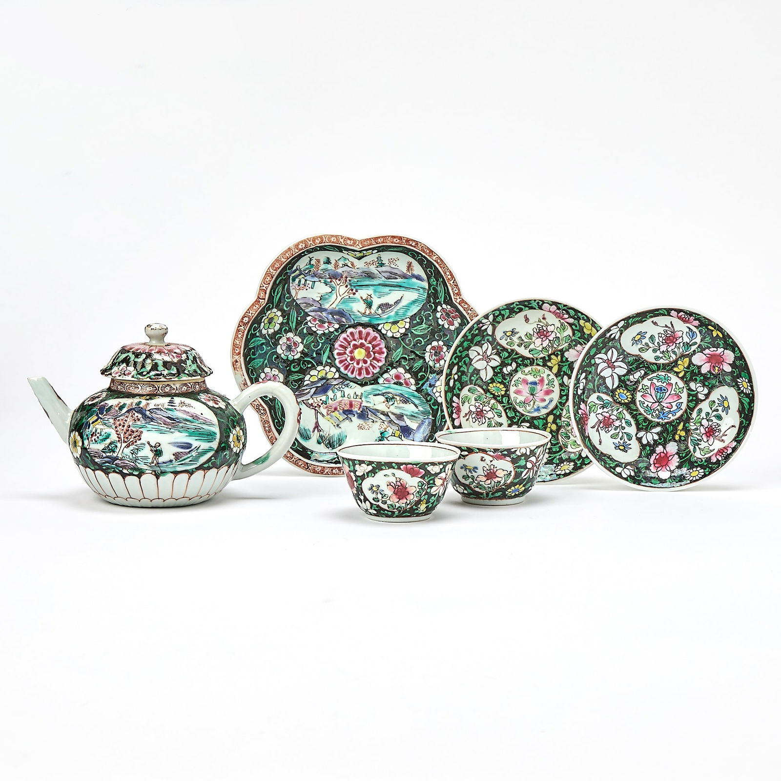 A Group of Chinese Export Black-Ground Famille Rose Porcelain Articles Qianlong Period: Comprising a teapot, two sets of dishes and saucers, and a flower-formed saucer dish. (Diameter of largest 6 inches)