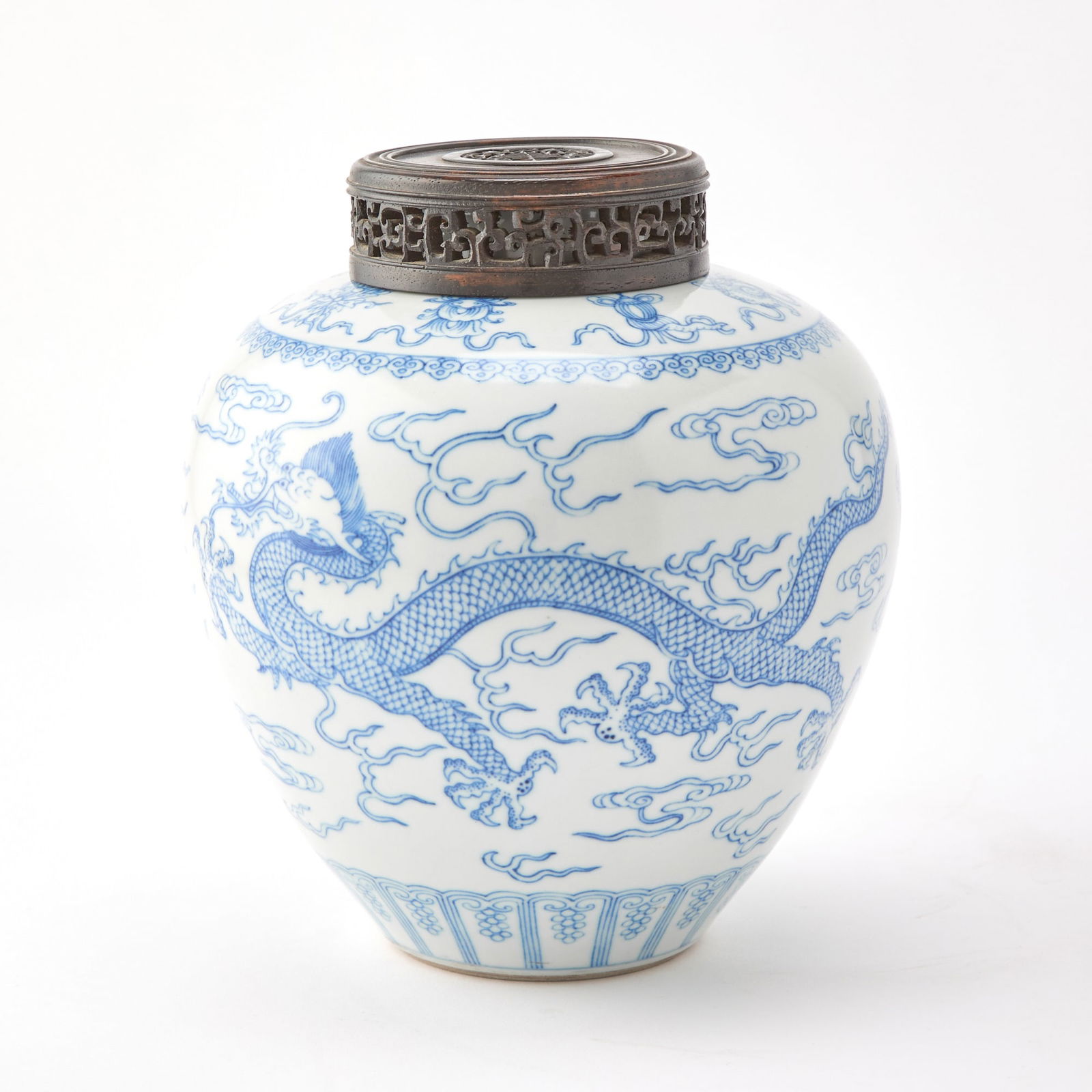 A Chinese Blue and White Porcelain Jar Qianlong Mark, 20th century: Decorated with sinuous dragons pursuing flaming pearls amongst flame wisps and scrolling clouds. (Height 8 1/2 inches)