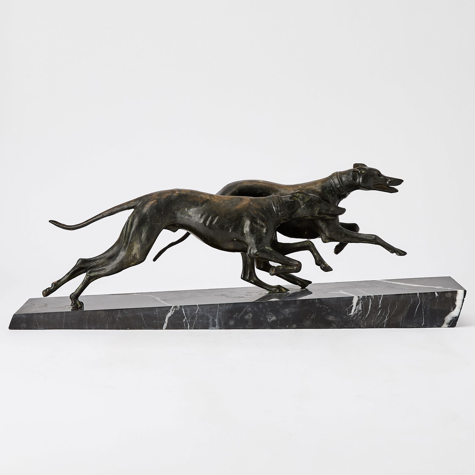 Continental School: 20th Century Two Greyhounds Racing Signed E. PAIE on the tail of one greyhound Bronze, mounted on a sloped marble base Bronze height 6 inches (15.2 cm) Overall 8 x 24 x 5 inches (20.3 x 61 x 12.7 cm)