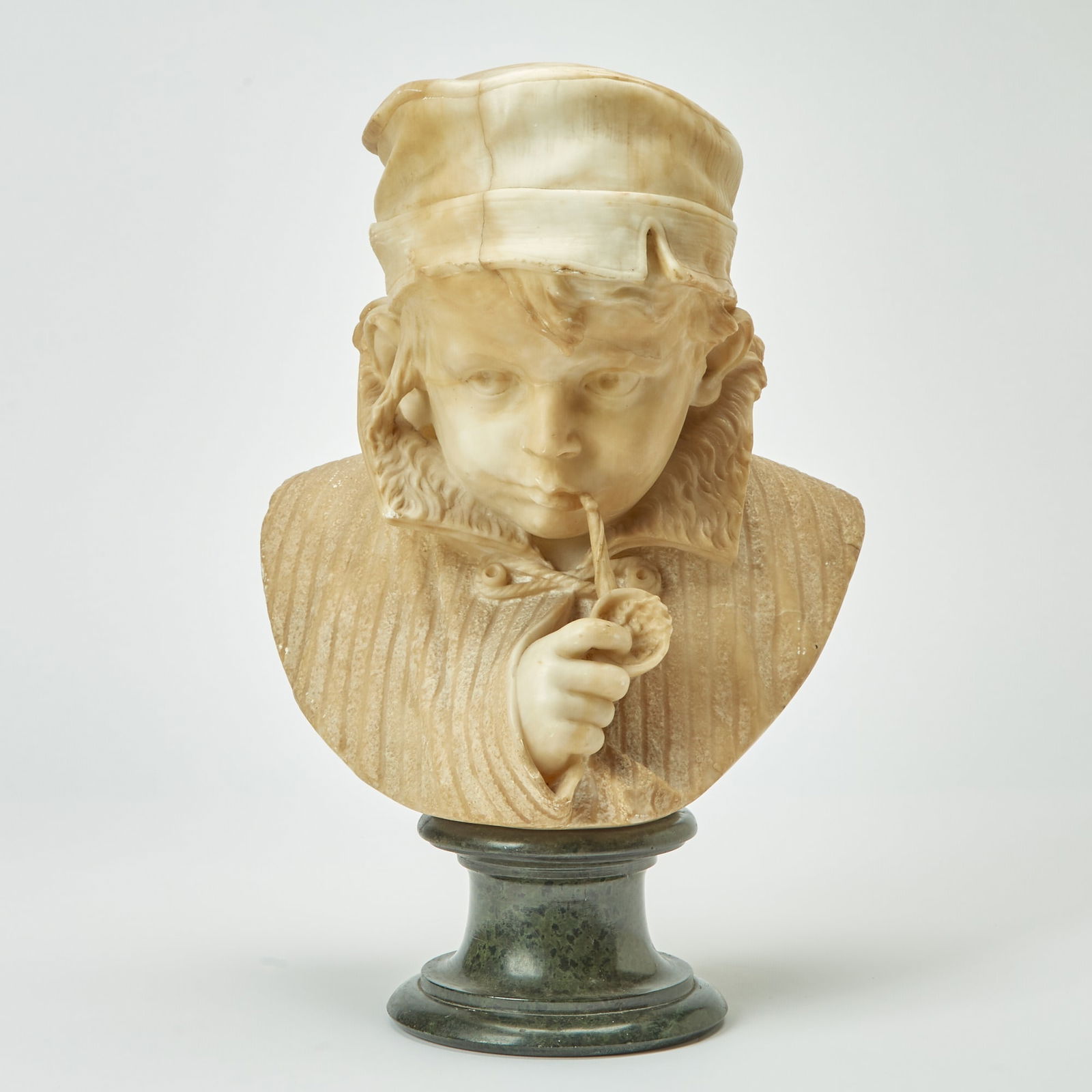 Italian Alabaster Figure of a Boy Smoking: Early 20th century On a green marble socle. Height 16 1/2 inches.