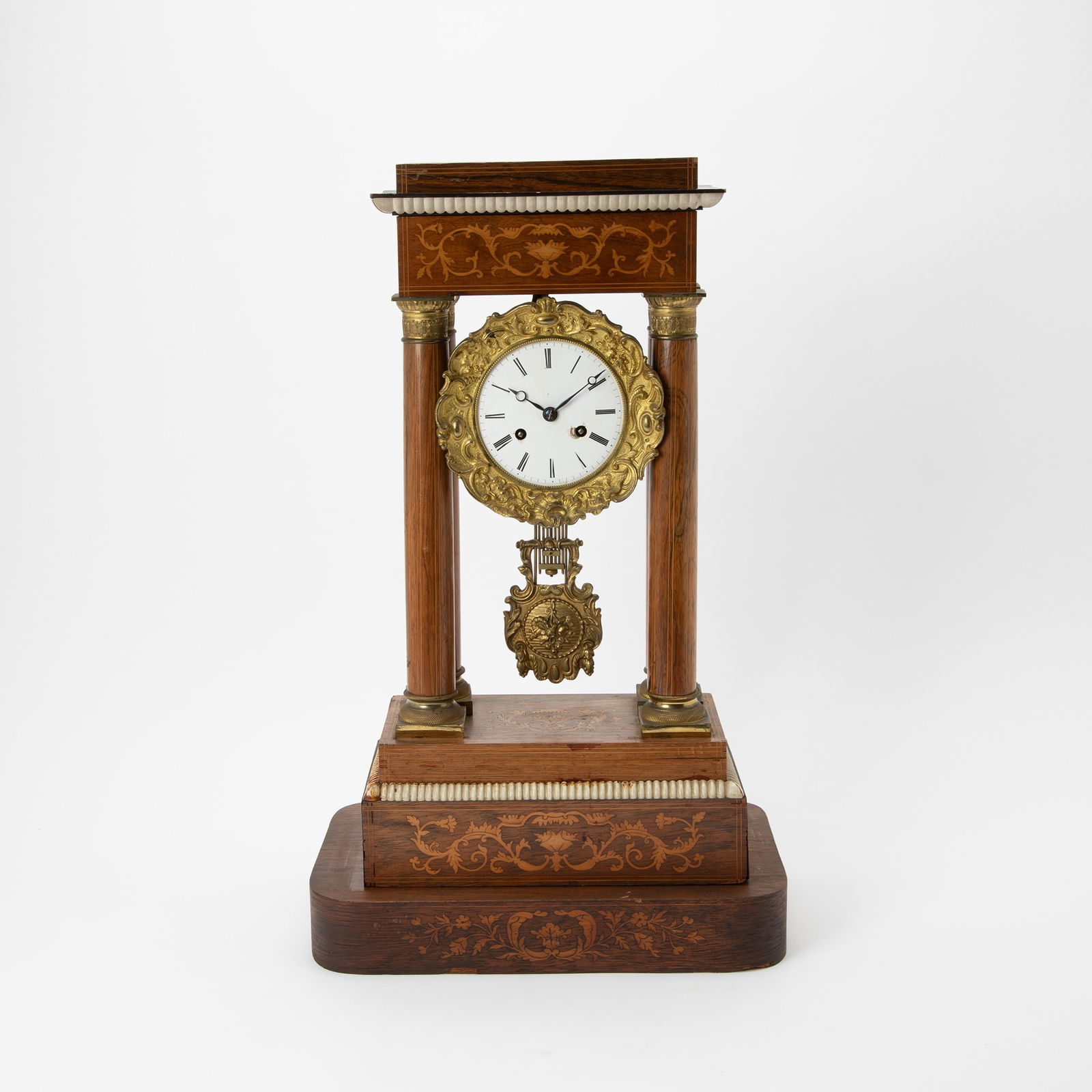 Louis Philippe Inlaid Rosewood Portico Clock: Second quarter 19th centuryHeight 22 inches, width 13 1/4 inches, depth 7 1/2 inches. With an acrylic case. fading, dry wood, losses