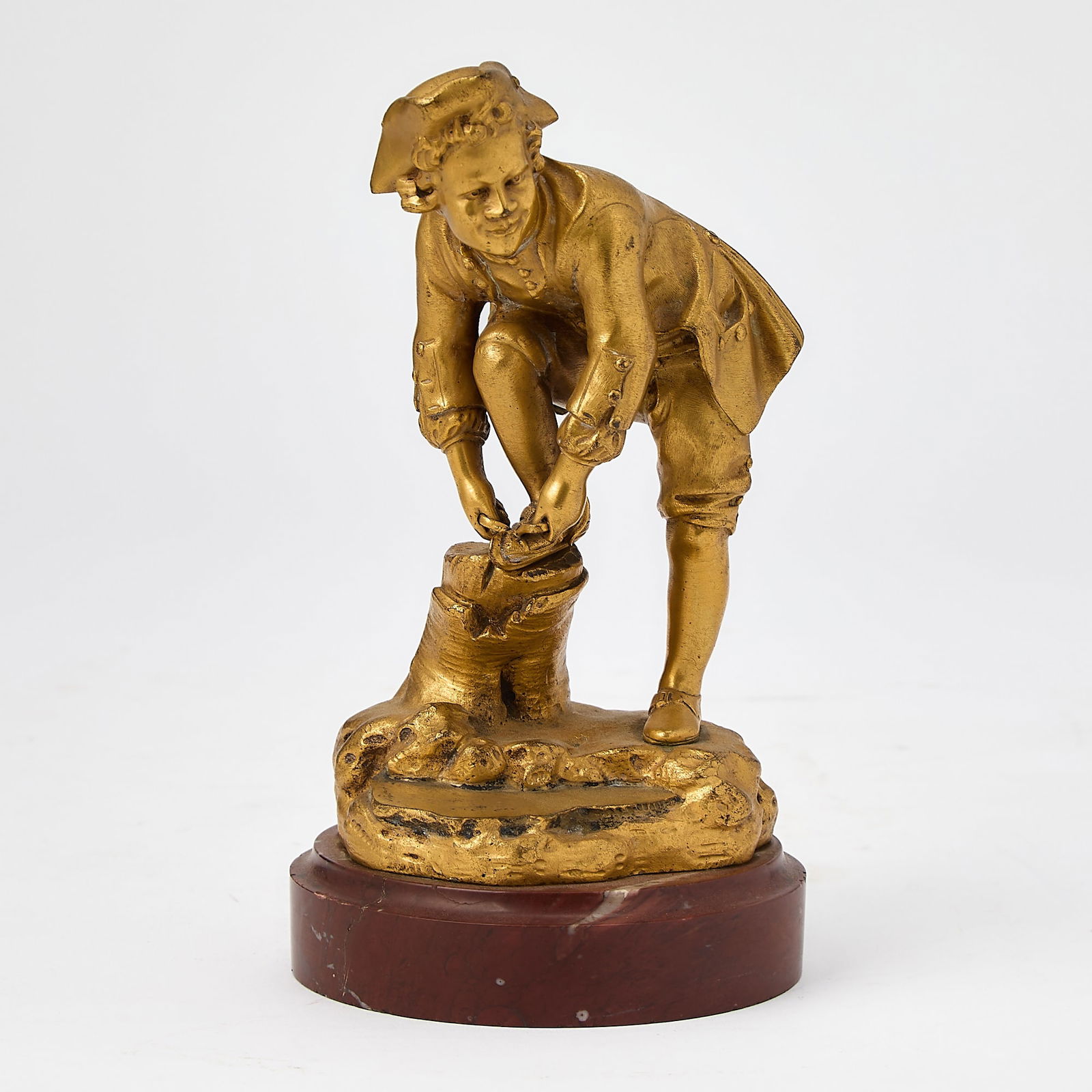 Gilt-Bronze Figure of a Boy Tieing His Shoe: On a marble base, inscribed Wald cisele. Height 7 12 inches. 