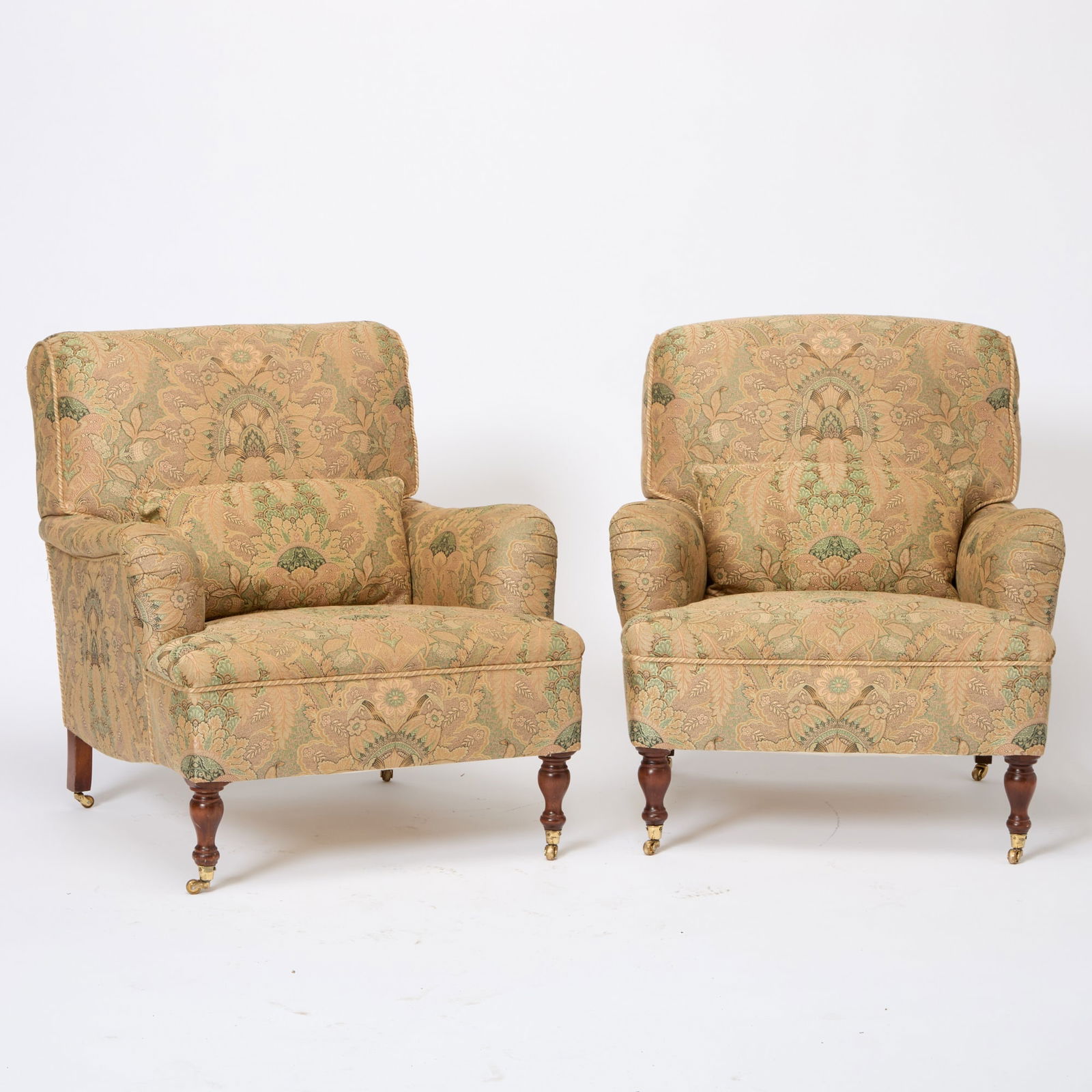 Pair of Upholstered Club Chairs: Late 20th centuryIn the George Smith style with mahogany legs and brass casters. Height 34 inches, width 30 inches, depth 30 inches.