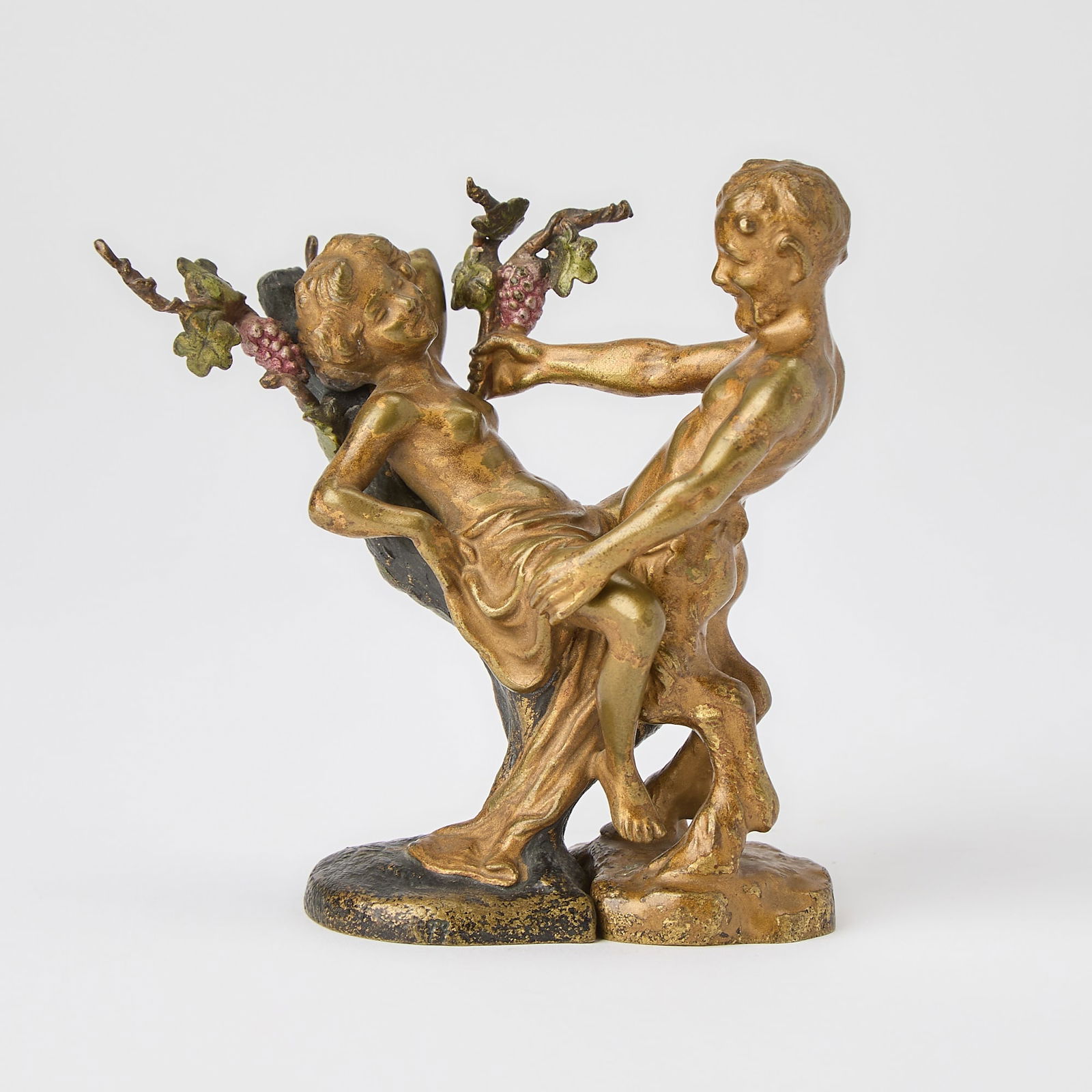 Franz Bergman Vienna Cold-Painted Bronze Interlocking Free-Standing Figures of a Nymph and Satyr: Circa 1915-20 Modeled as separate figures, comprising a young male satyr modeled in a standing pose with an offering of grapes, impressed numeral 4 on the underside; and a seminude young woman modeled