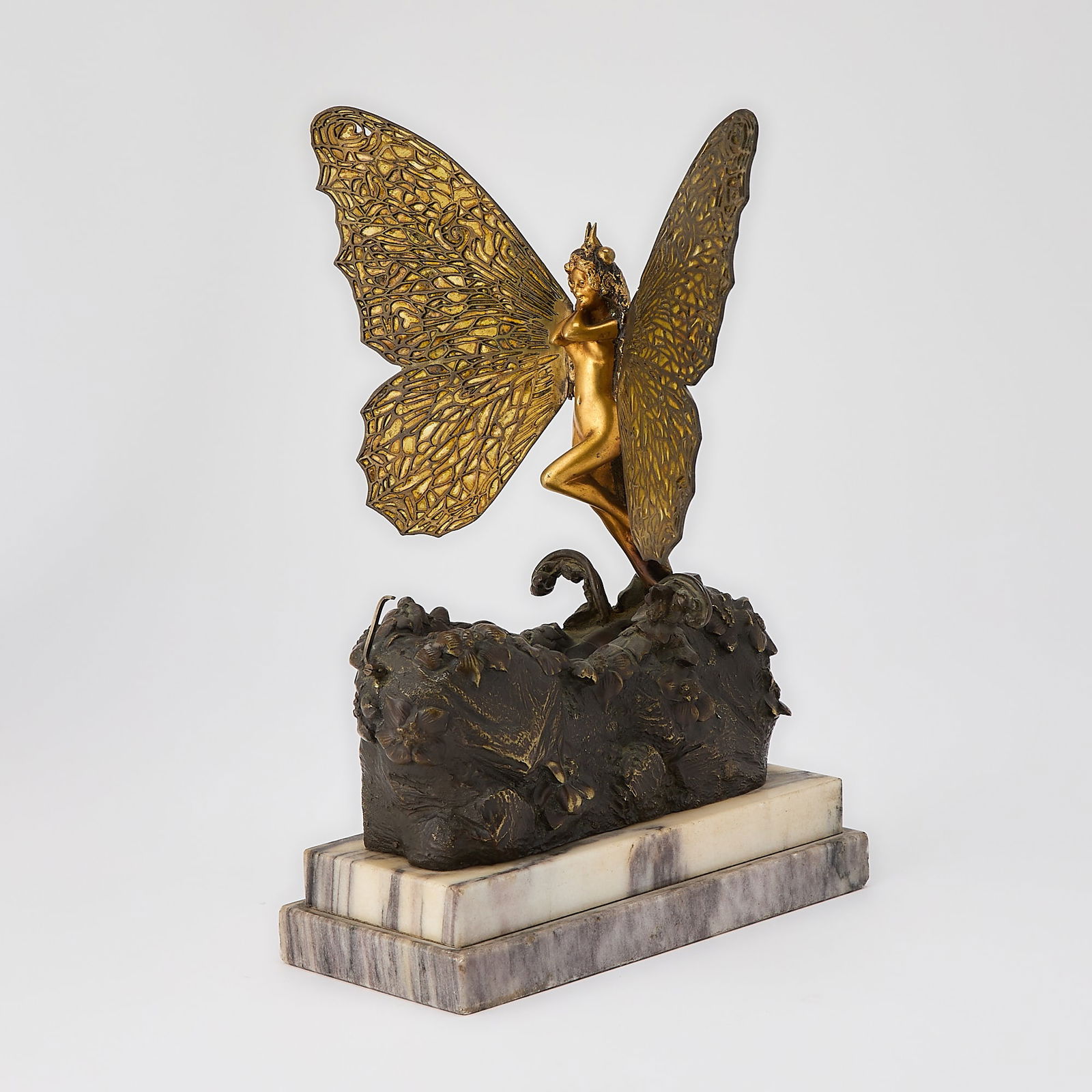 Carl Kauba Vienna Gilt and Patinated Bronze and Plique-à-Jour Enamel Mechanical "Butterfly": Entitled "Metamorphosis," early 20th century Modeled as a butterfly poised at rest, its filigree wings adorned with yellow enamel, set atop a naturalistic cocoon-like rocky base embellished with scatt