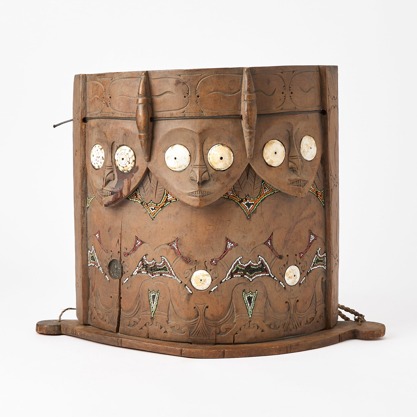 Dayak Baby Carrier: Carved with shell and bead embellishment. Height 15 inches, width 18 inches. depth 8 inches. one shell loose