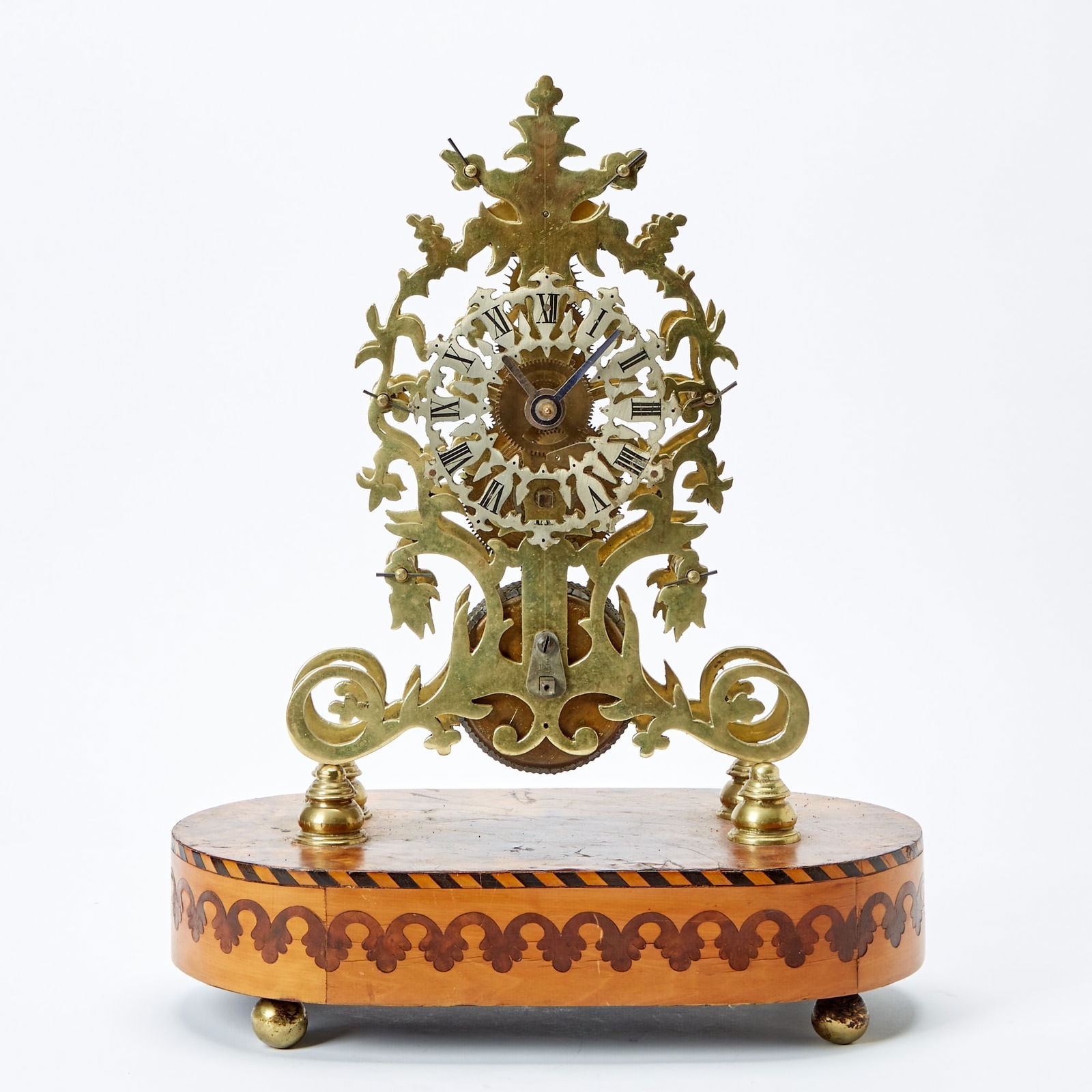 English Brass and Inlaid Wood Skeleton Clock: Late 19th century Height 16 inches, width 13 inches.