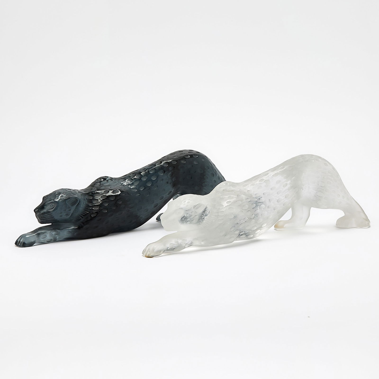 Two Lalique Molded Glass Panthers: Modern One in black glass, the other frosted. Lengths 15 inches. generally good condition