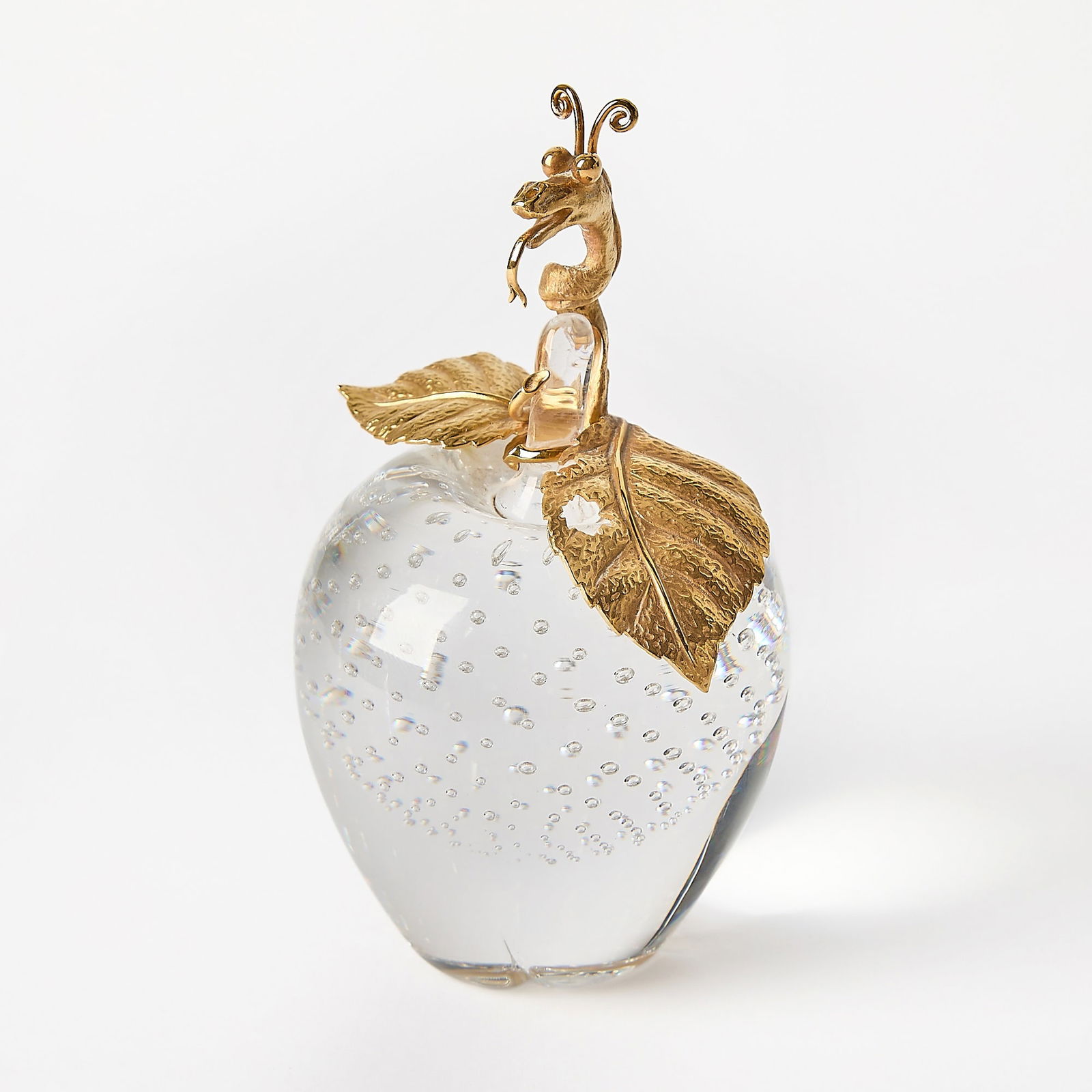 Steuben 18K Gold-Mounted Glass Apple of Eden: Designed by James Houston (1921-2005), circa 1971 Controlled bubble colorless glass apple with 18K gold serpent, stem and leaves. Height 6 inches.