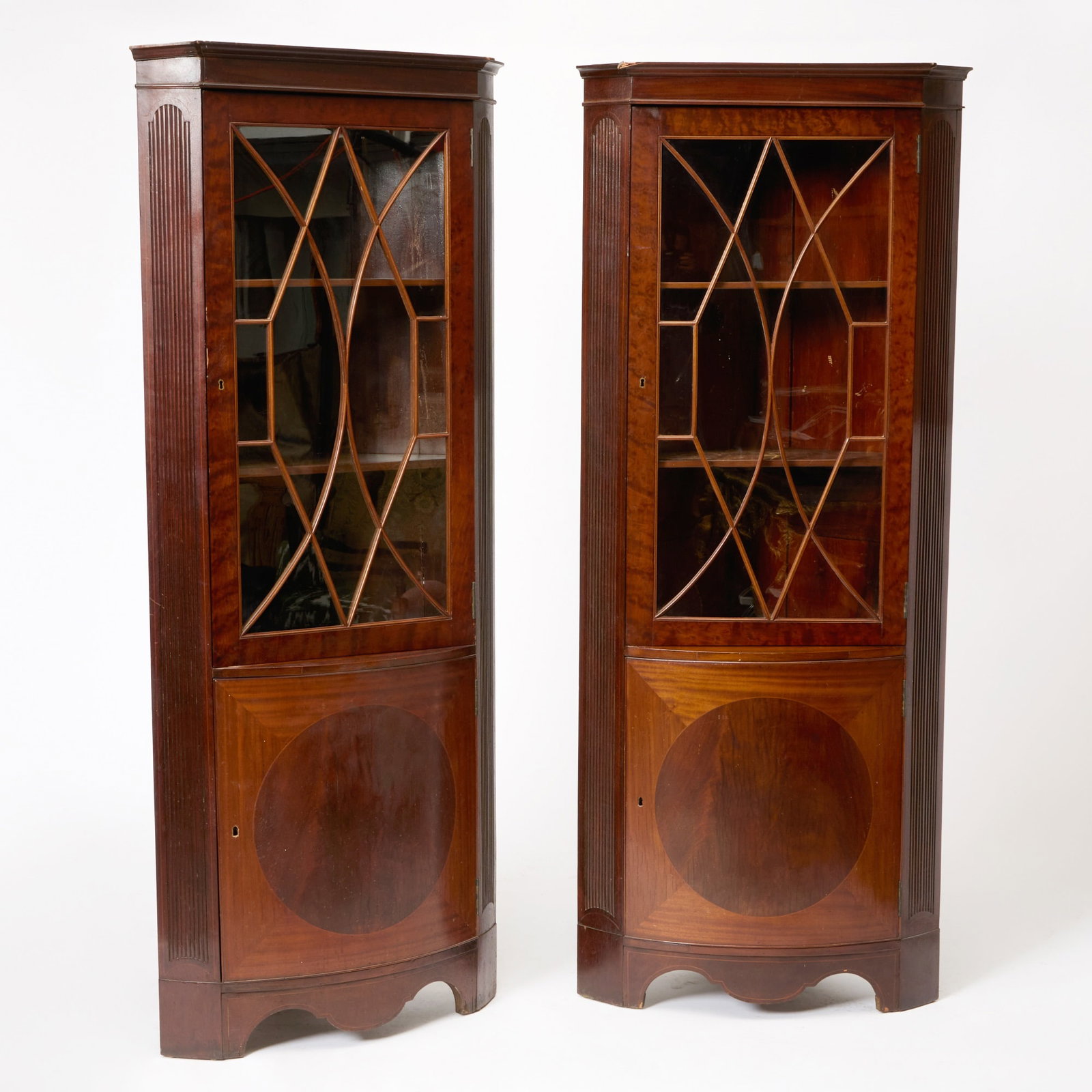 Pair of George III Mahogany Corner Cabinets: Height 7 feet 7 inches, width 23 1/2 inches, depth approximately 24 inches.