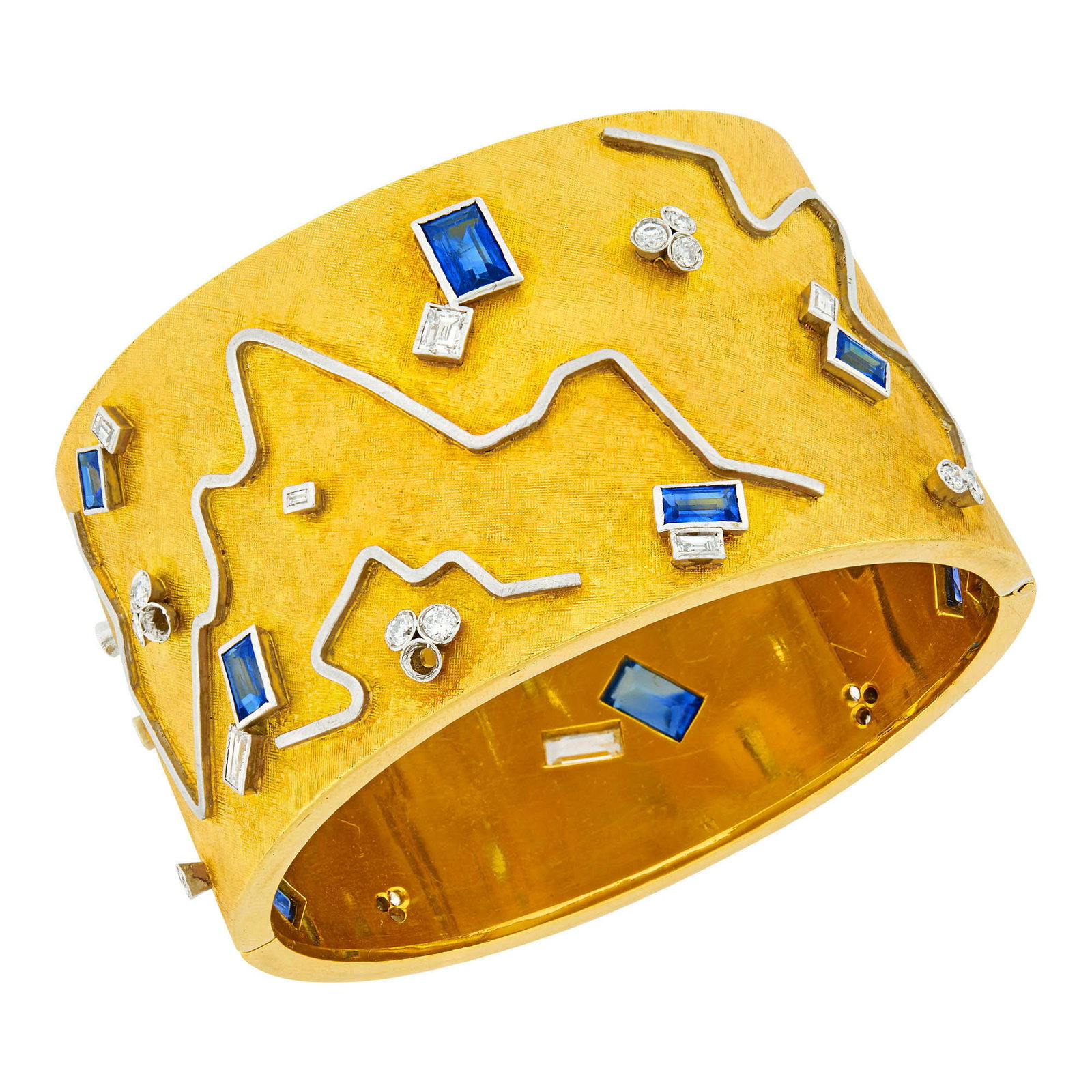 Gold, Platinum, Diamond and Sapphire Cuff Bangle Bracelet: 22 round and single-cut and 13 baguette diamonds ap. 1.65 cts., 10 rectangular-cut sapphires ap. 4.00 cts., two diamonds missing, ap. 71.3 dwts. Inner cir. 6 1/4 inches. Tests for 18 kt. Diamonds: I-