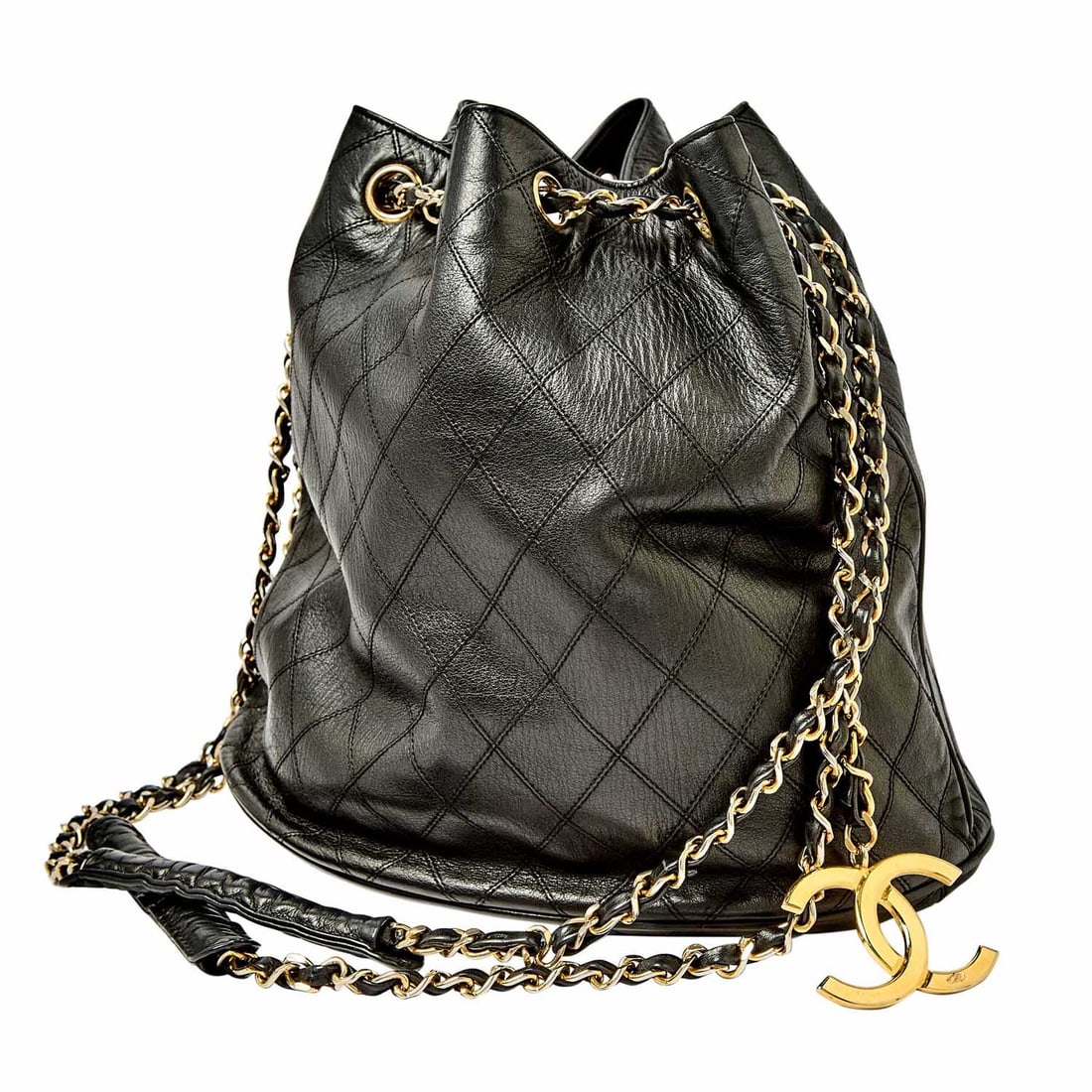 Chanel Black Quilted Leather Bucket Bag: Quilted black leather with gold-tone hardware, double 'CC' charm and woven-through leather chain strap, signed Chanel, no. 0650405, c. 1986-1988. 10 5/8 x 14 x 7 1/4 inches. * Visibl