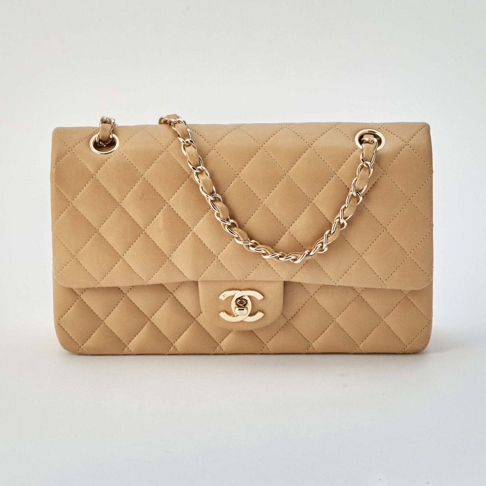 Chanel Beige Lambskin Flap Bag: Double flap bag with gold-plated hardware, double 'CC' turn lock closure and woven-in leather chain strap, matching leather interior with two compartments, main compartment with two slip pockets, zipp