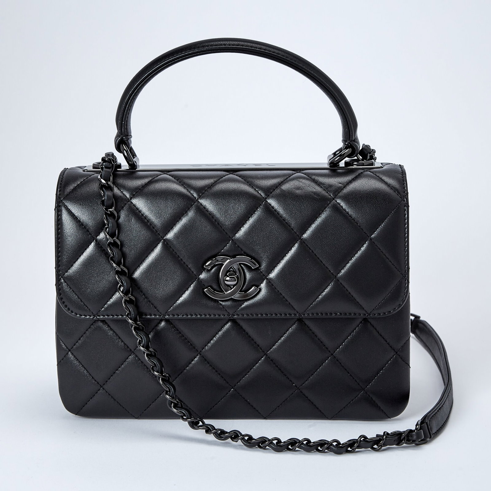 Chanel Black Lambskin Leather ‘Trendy’ Flap Bag: Flap bag with black hardware, double 'CC' turn lock closure, top handle and woven-in leather chain strap, black leather interior with three compartments, two slip pockets and zippered side pocket, wit