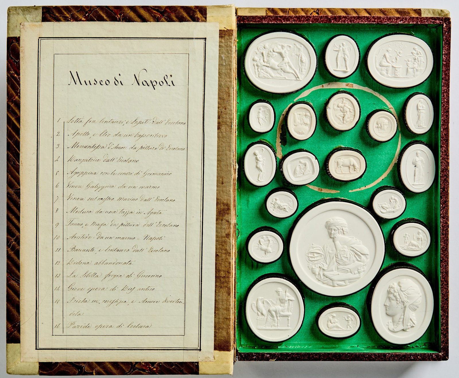 Nineteen volumes of plaster casts from the Grand Tour: LIBEROTTI, GIOVANNI Liberotti Impronte [spine title]. Nineteen book-form boxes of plaster intaglios. [Rome: Giovanni Liberotti, 1820s-1830s]. Publisher's vellum spines gilt with red leather labels, ma
