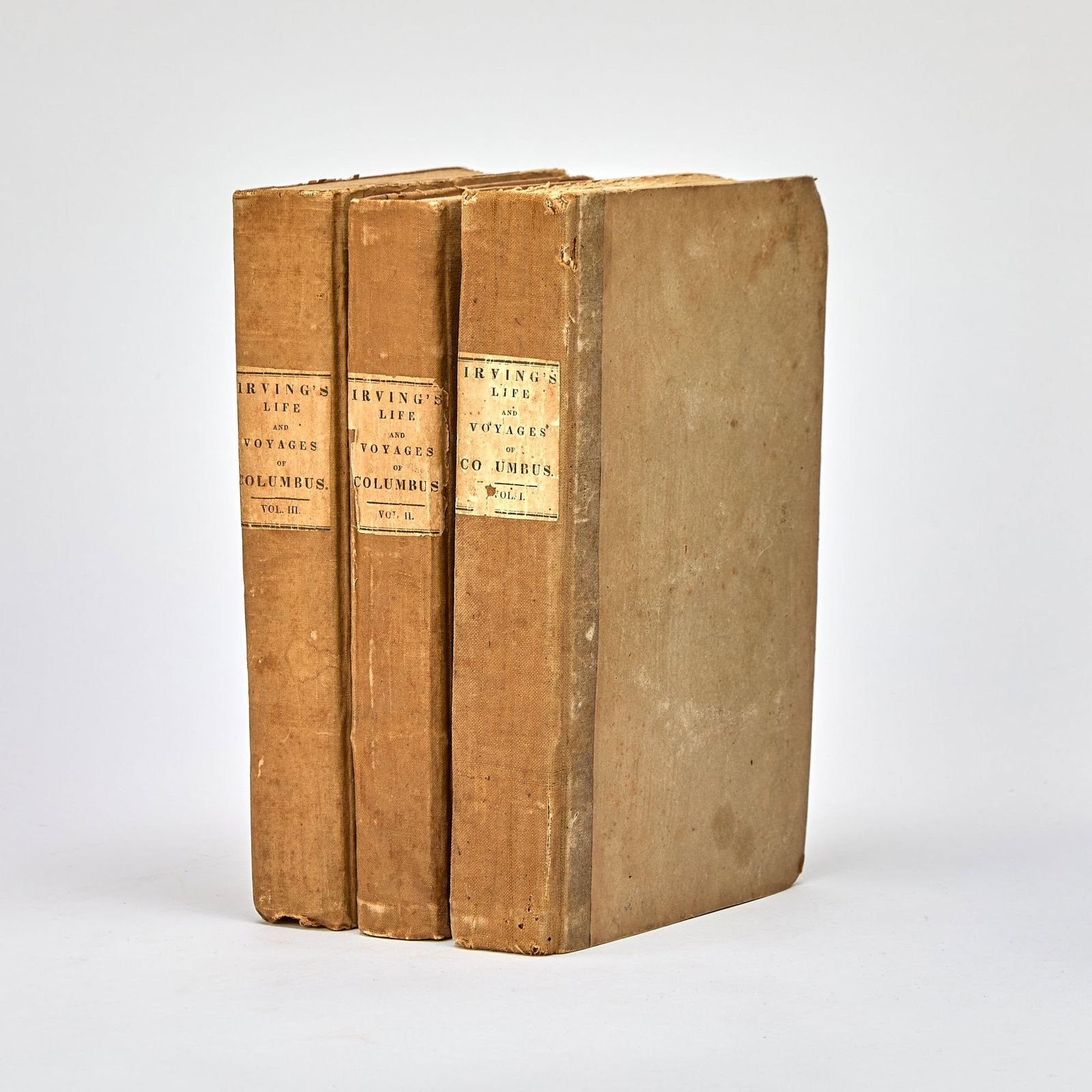 First American edition of Irving's Life and Voyages of Columbus, in original boards: IRVING, WASHINGTON Life and Voyags of Christopher Columbus. New York: G. & C. Carvill, 1828. First American edition. Three volumes. Original linen-backed boards, with printed paper labels to spin