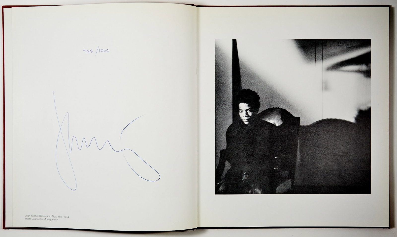 One of a thousand copies signed by Jean-Michel Basquiat: [BASQUIAT, JEAN-MICHEL] Jean-Michel Basquiat. Zurich: Gallery Bruno Bischofberger, (1985). Copy 588 of 1000, numbered and signed as issued by Basquiat on the leaf opposite his portrait. Publisher's br