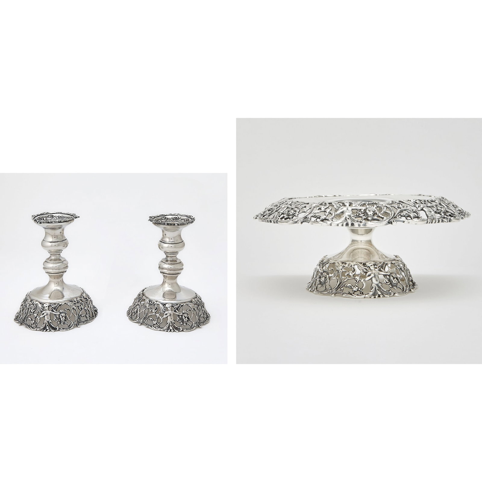 American Sterling Silver Table Garniture: Durham Silver Co., mid 20th century Comprising a centerpiece bowl and pair of candlesticks, each with openwork border of lion masks, cherubs and foliate scrolls. Height of bowl 4 inches, diameter 9 1/