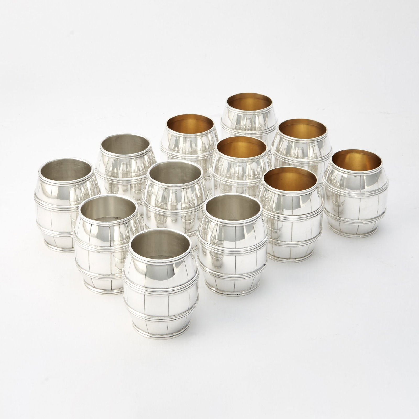 Set of Twelve Tiffany & Co Sterling Silver Novelty Barrel-Form Beakers: Second half 20th century Height 2 1/2 inches, total approximately 43 ounces. Generally good condition overall with light wear from casual use