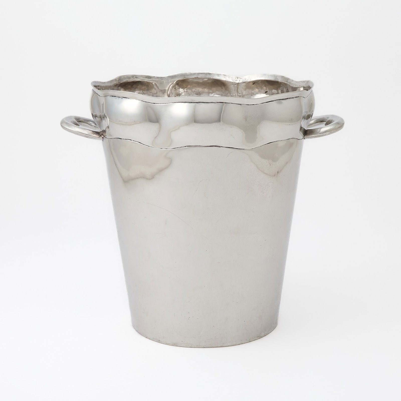 Mexican Sterling Silver Wine Cooler: Mid 20th century Tapering cylindrical with lobed rim and two loop handles. Height 8 1/2 inches, length over handles 9 1/2 inches, approximately 39 ounces. Generally good condition overall with light