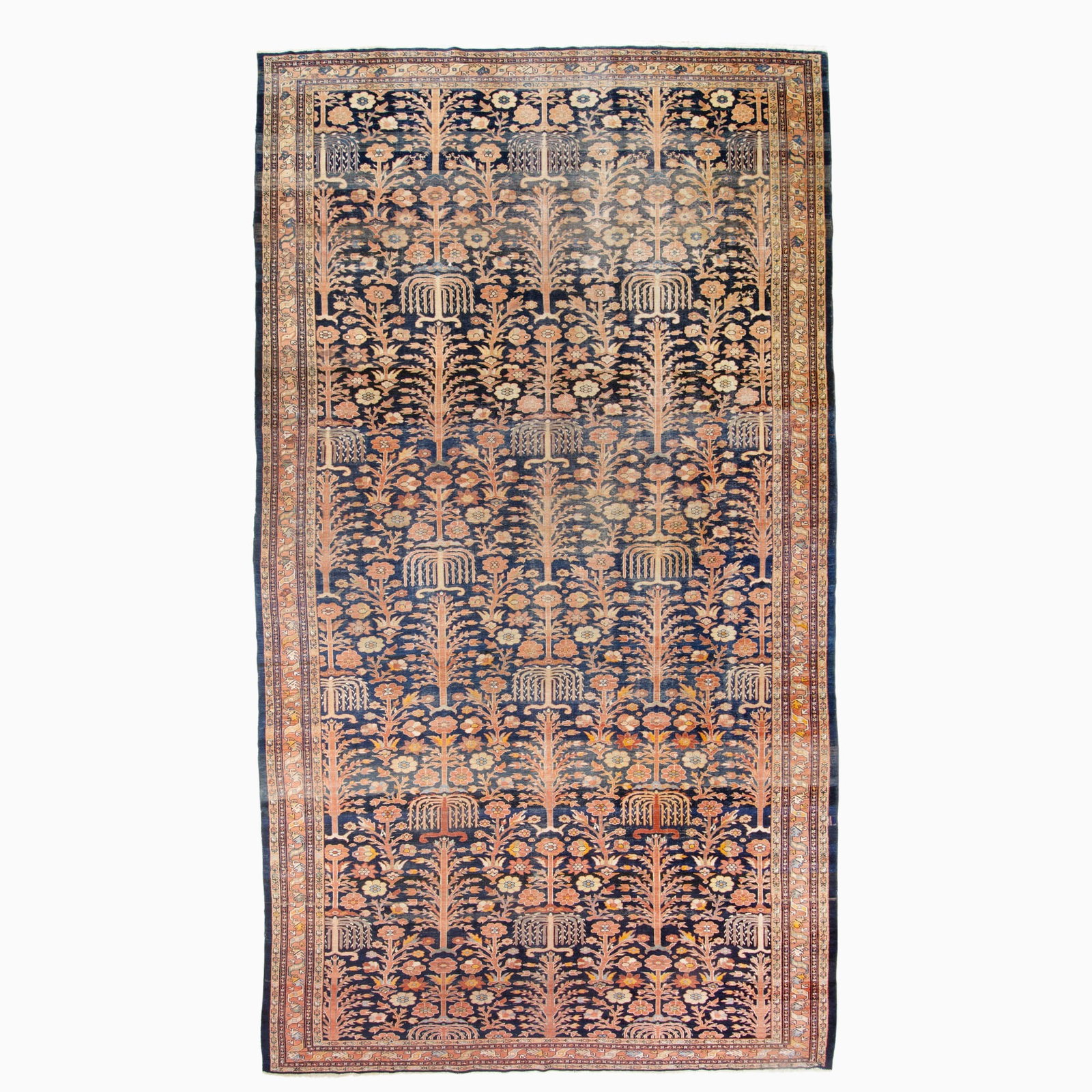 Northwest Persian Carpet: Northwest Persia, First 1/4 20th Century The ascending pattern of trees and shrubs on the abrashed indigo field is within a madder meandering vine border. (23' 2" x 10' 4") Areas of wear, tinted areas