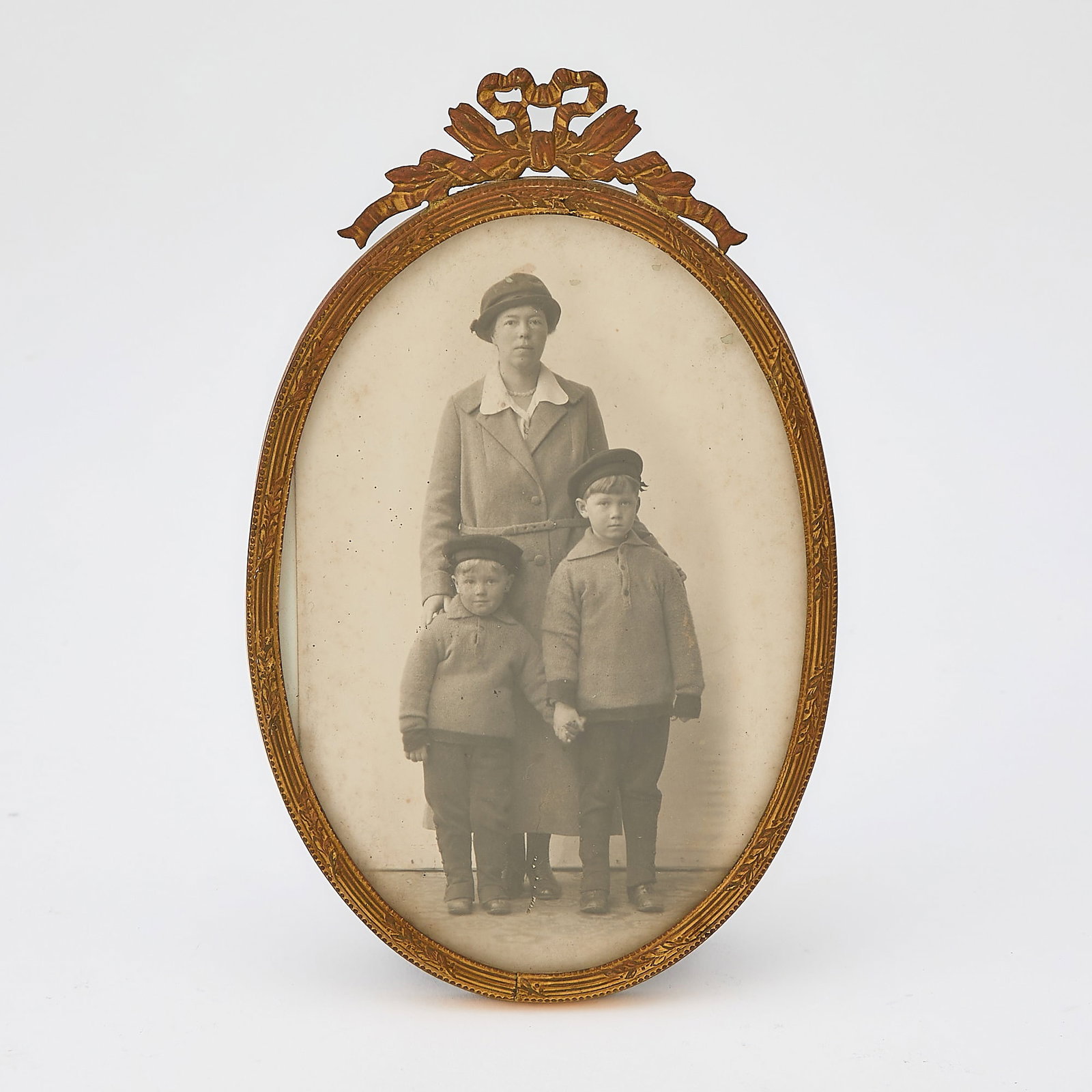 Portrait of Grand Duchess Olga of Russian and Her Two Sons: Early 20th century The Grand Duchess pictured with her sons, Tikhon and Guri, in a gilt-metal frame. Height 6 3/4 inches (17 cm). Provenance: Grand Duchess Olga Alexandrovna of Russia (1882–1960