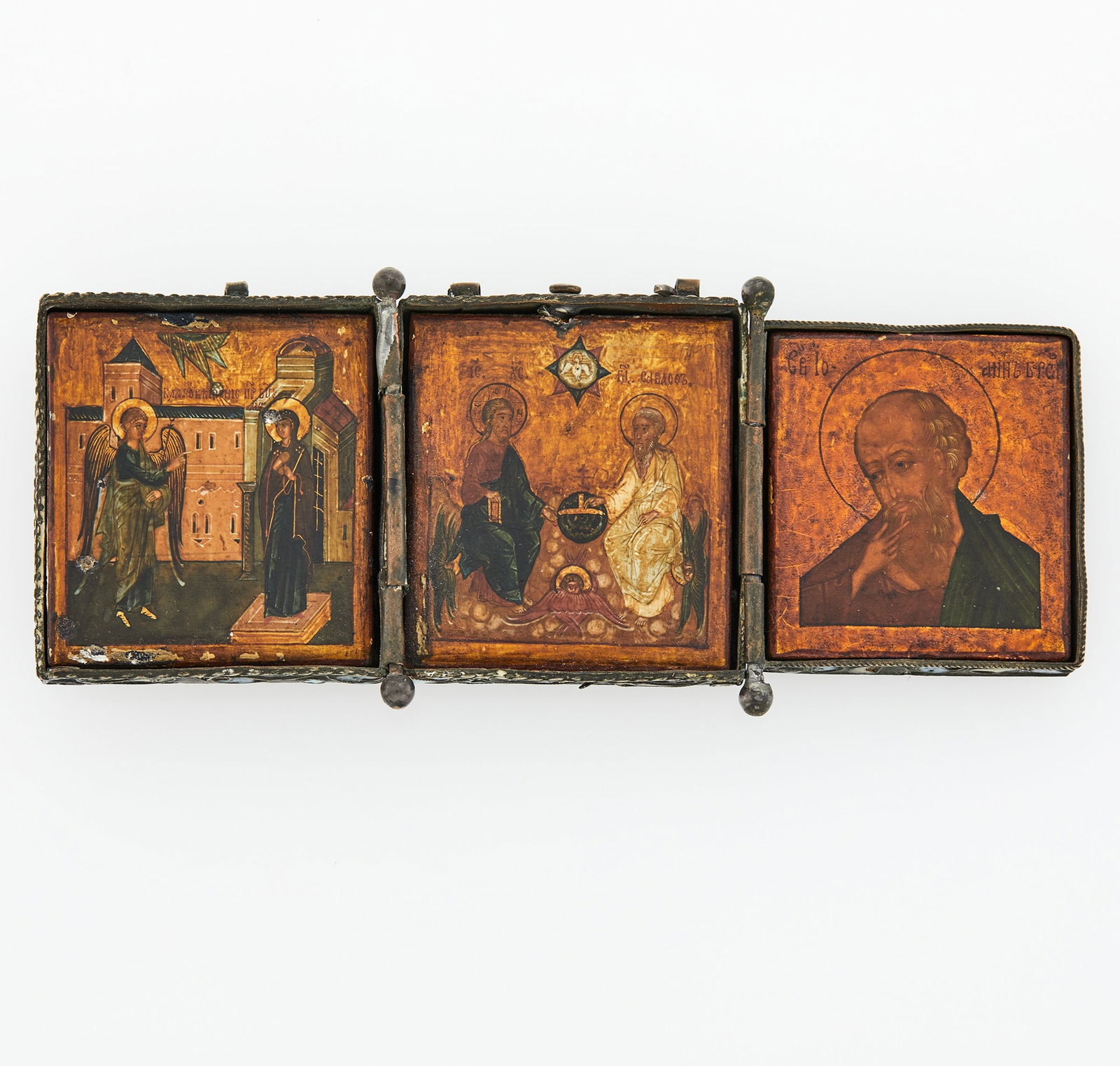 Russian Silver and Cloisonné Enamel Triptych Icon: Unmarked, late 17th century Centering an icon of the New Testament Trinity, flanked by icons of the Annunication and St. John the Theologian, the exterior of the case enameled with foliage in blue, tu