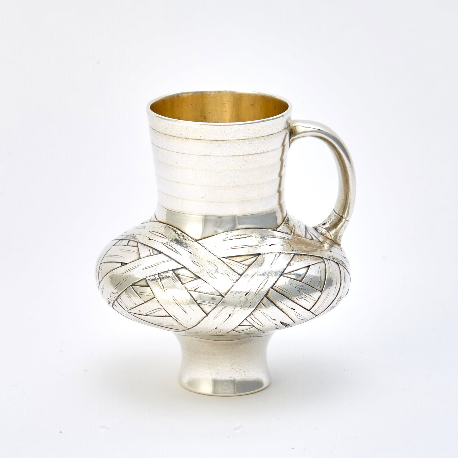 Russian Silver Trompe l'Oeil Jug: Ovchinnikov, Moscow, 1871 Of typical form, with loop handle, the body chased to simulate basket weave. Height 3 1/4 inches (8.25 cm), approximately 4 ounces (127 grams).