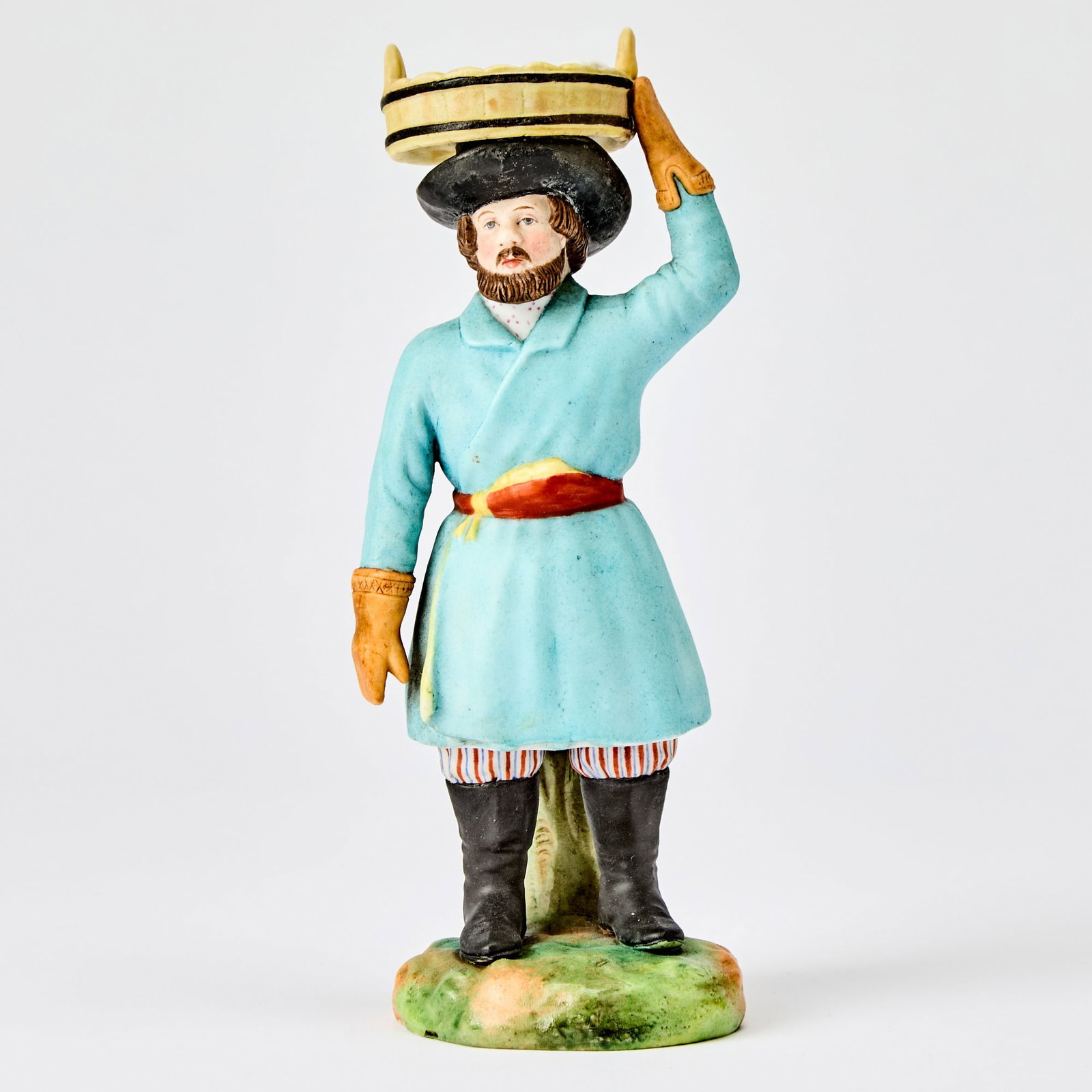 Russian Porcelain Figure of a Fish Vendor: Kornilov Manufactory, St. Petersburg, 1861-1884 Height 7 1/4 inches (18.4 cm).