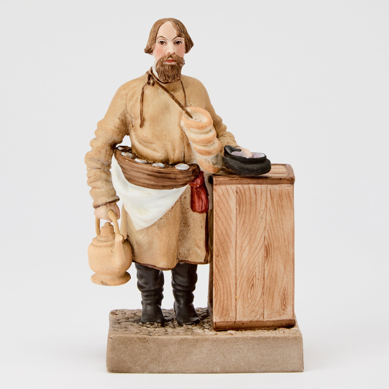 Russian Porcelain Figure of a Bagel and Sbiten Vendor: Gardner Manufactory, Verbilki, 1870s-1890s Height 6 inches (15.2 cm). Another version of this model is illustrated in Gardner: XVIII - XIX: Porcelain Plastic Arts from Private Collections & Mosco